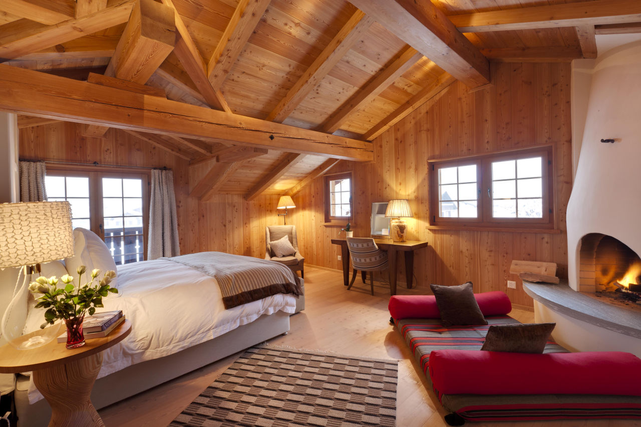 Master double en-suite bedroom with fireplace in Chalet Chimera in Klosters