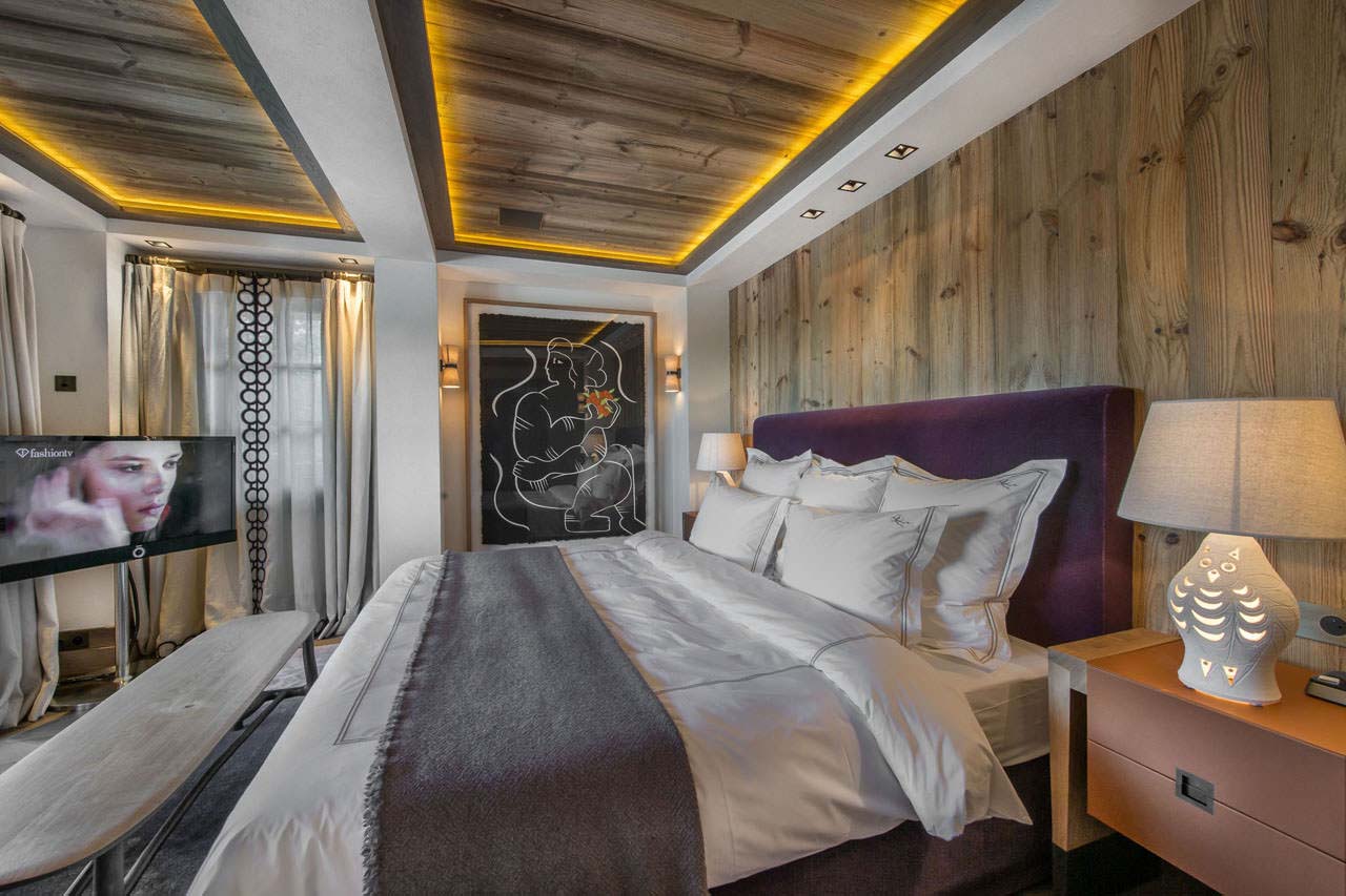 En suite master bedroom with king-size bed in Chalet Cryst'Aile in Courchevel 1850