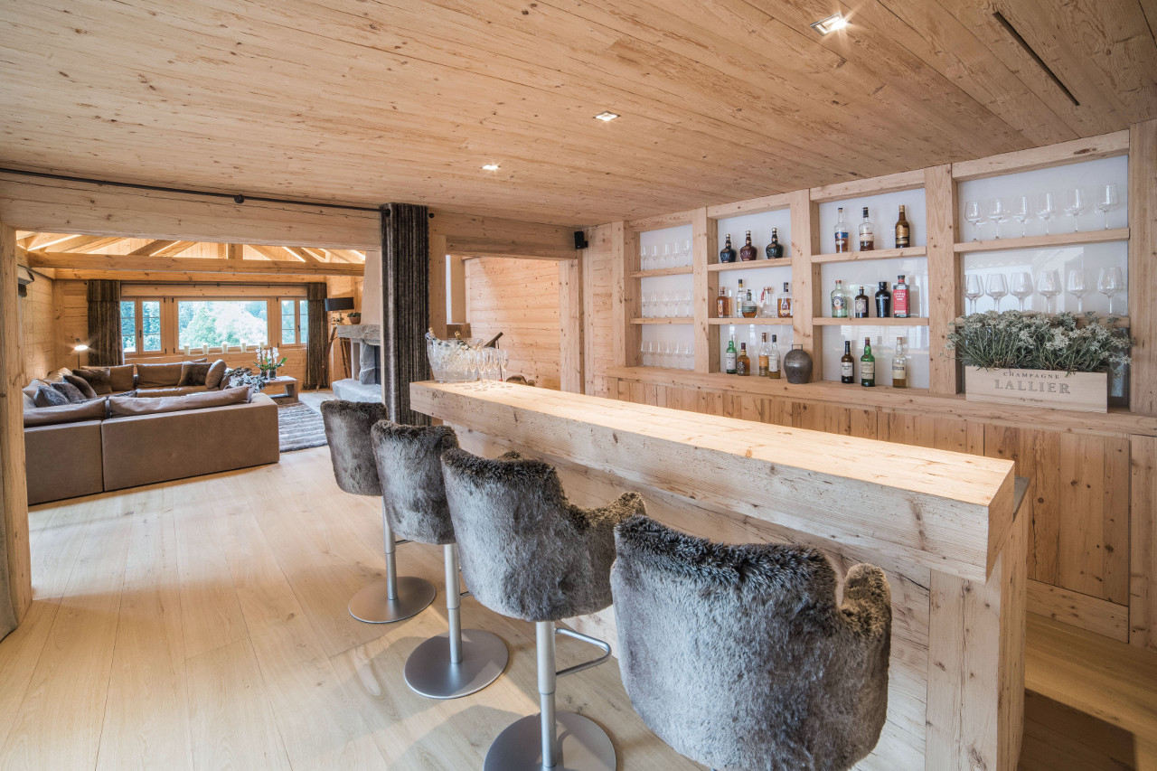 Well-stocked bar in living space of Chalet de Rougemont in Gstaad