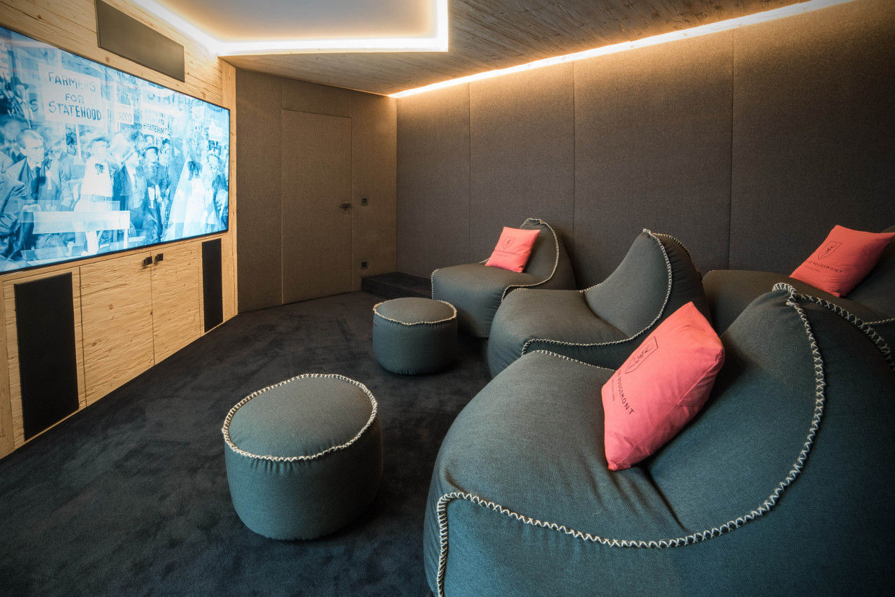 Cinema lounge with soft chairs in Chalet de Rougemont in Gstaad