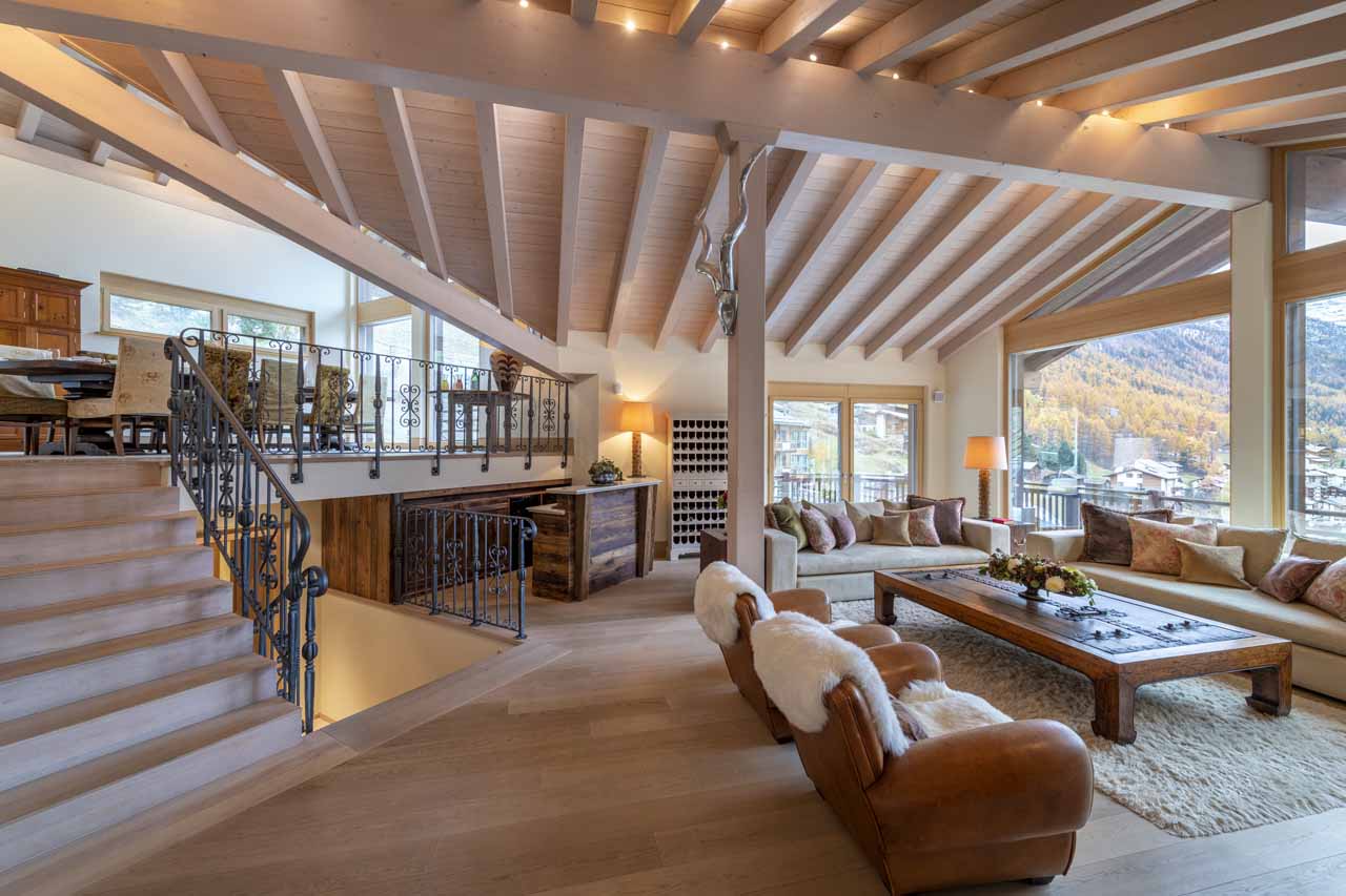 Open plan living area and elevated dining area at Chalet Grace in Zermatt