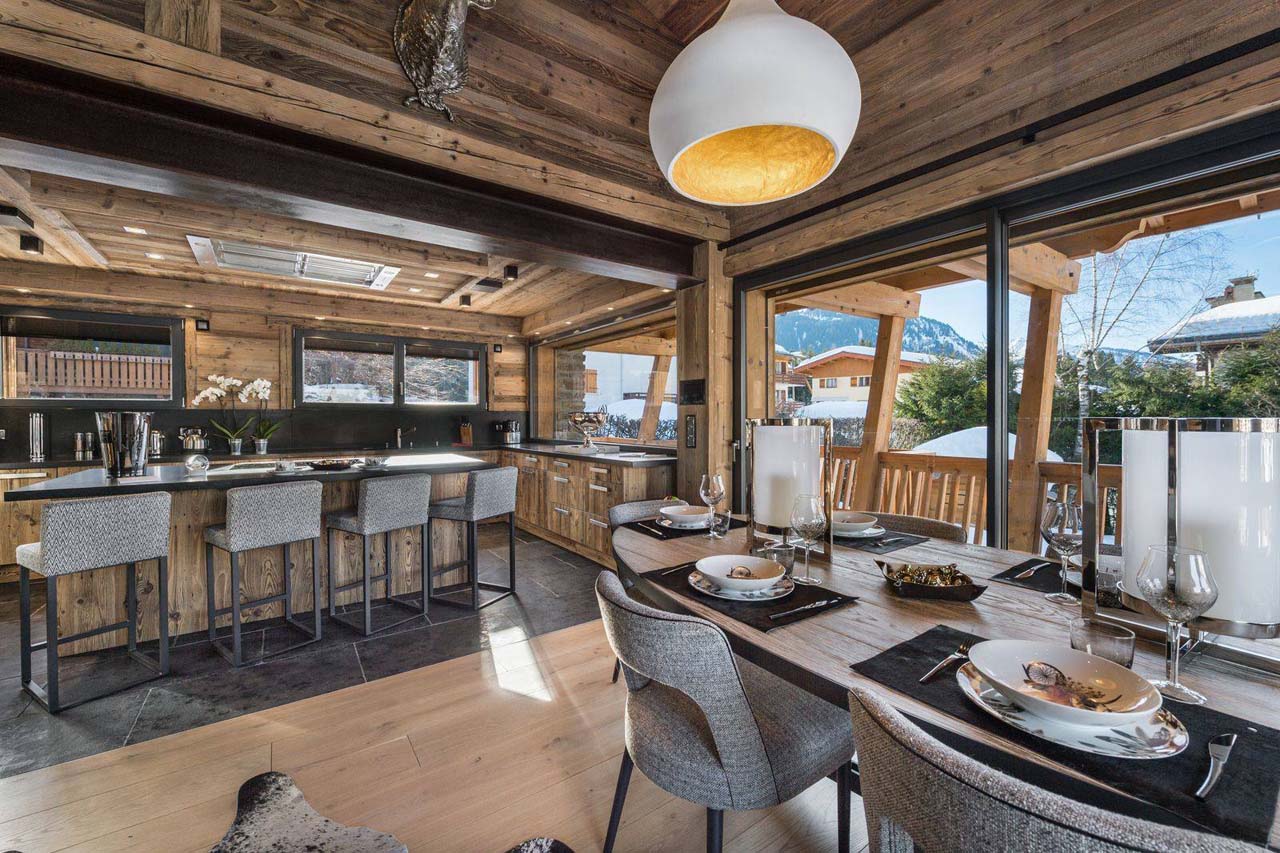 Dining table and kitchen at Chalet Lamartine in Megeve