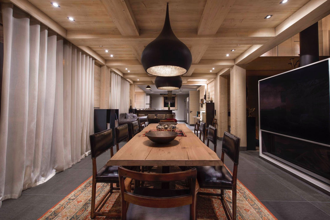 Dining room with balcony access in Chalet Migui in Crans-Montana