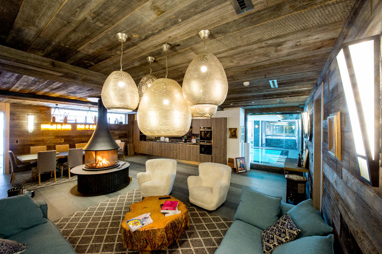 Entertainment room with fireplace of Chalet Migui in Crans-Montana