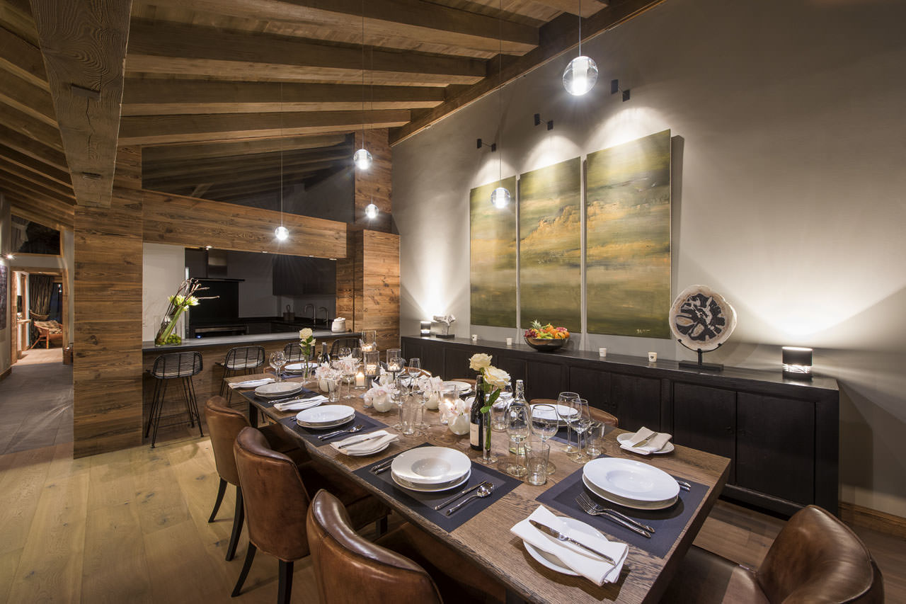 Dining table and kitchen in Le Daray Penthouse in Verbier