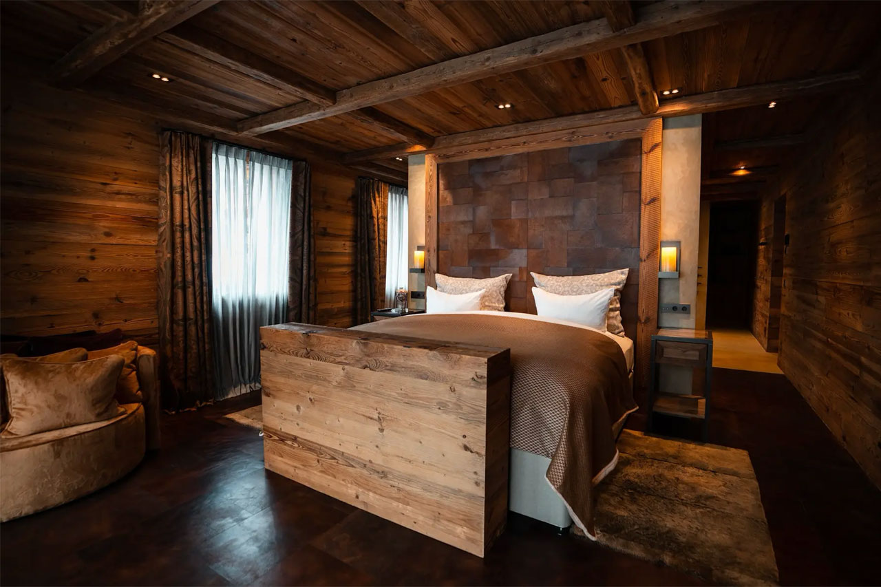 Master bedroom with dressing room and balcony access in Chalet 1551 in Lech