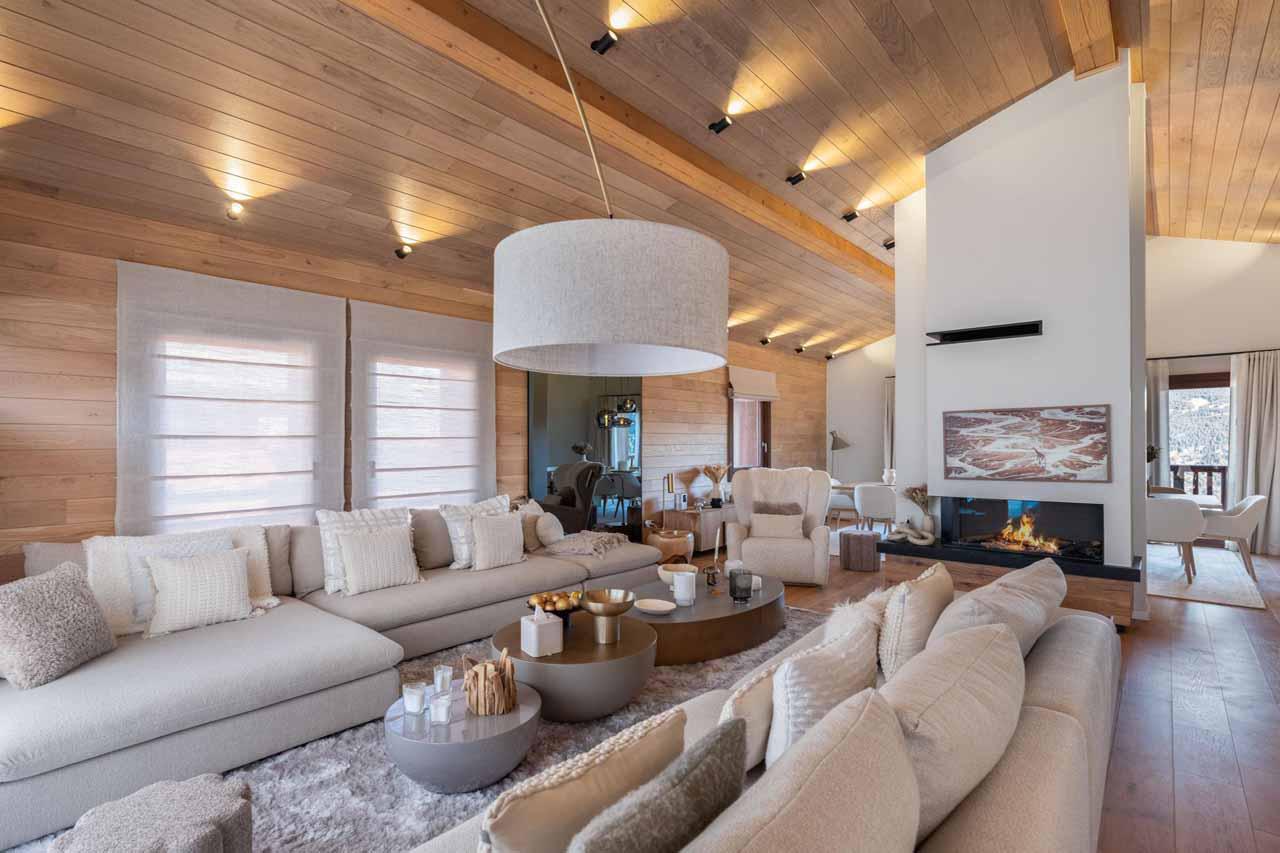 Sofas arranged around coffee table and fireplace in Chalet Arpont, Courchevel 1650
