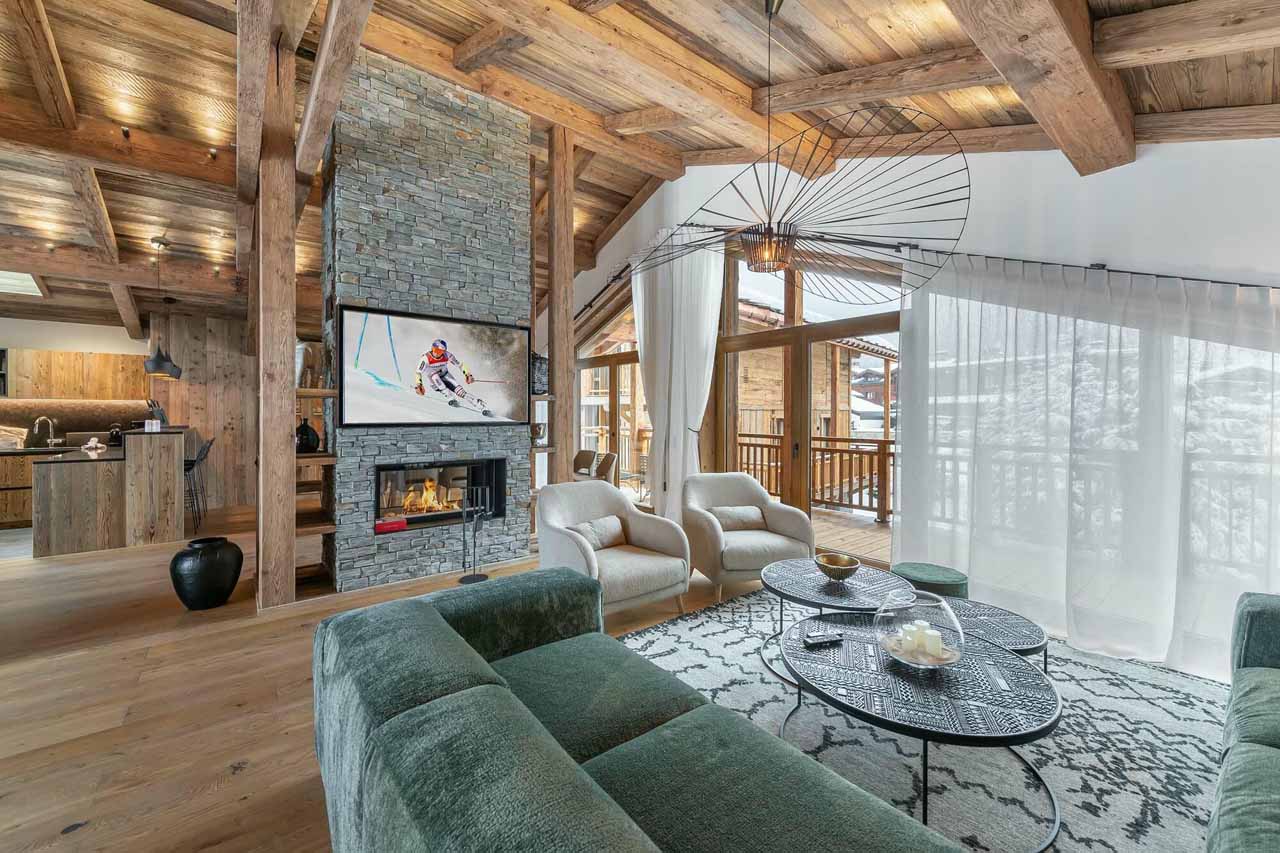Living area with fireplace at Chalet Bois du Ban in Courchevel Le Praz