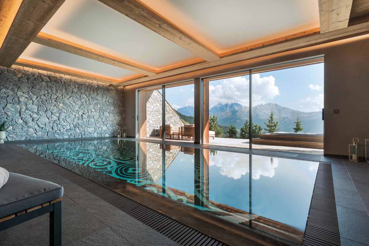 Swimming pool and relaxation area at Chalet Calima in Verbier