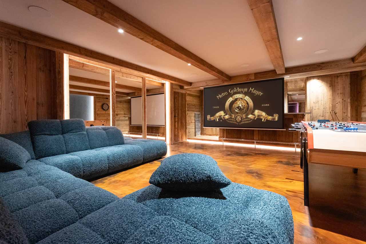 Wrap-around sofa and projector screen in Chalet Grande Kalinka, Meribel