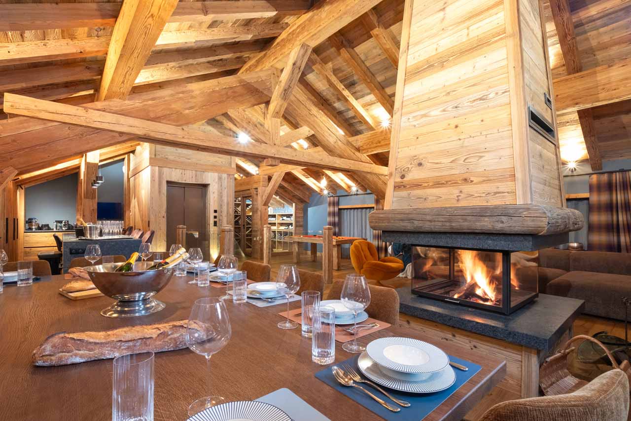 Dining table and fireplace in Chalet Grande Kalinka, Meribel