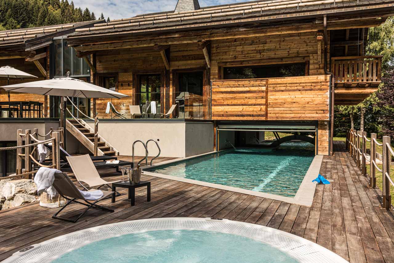 Indoor/outdoor pool and hot tub at Chalet Joux Plane in Morzine in summer