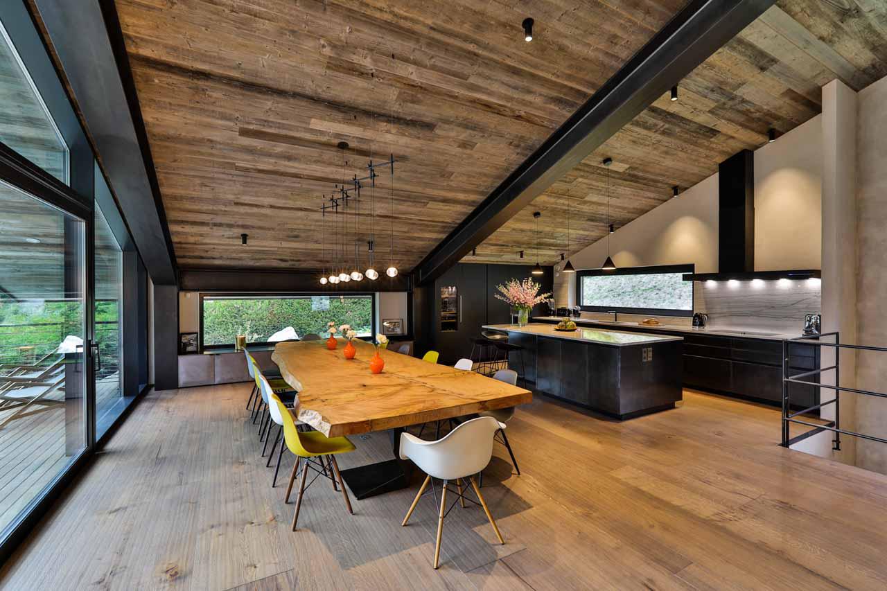 Dining table and kitchen at Chalet On The Rocks in Chamonix