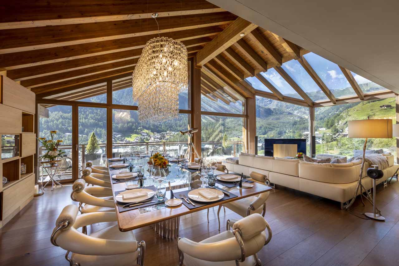 Open plan living and dining area at Chalet Zermatt Peak in summer
