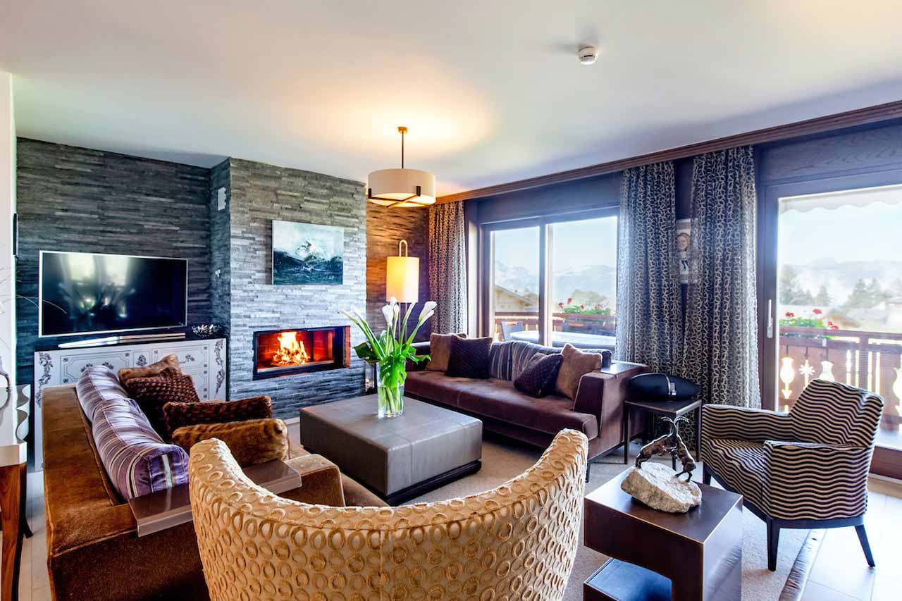 Fireplace in living room of Royalp Family Duplex Residence in Villars-sur-Ollon