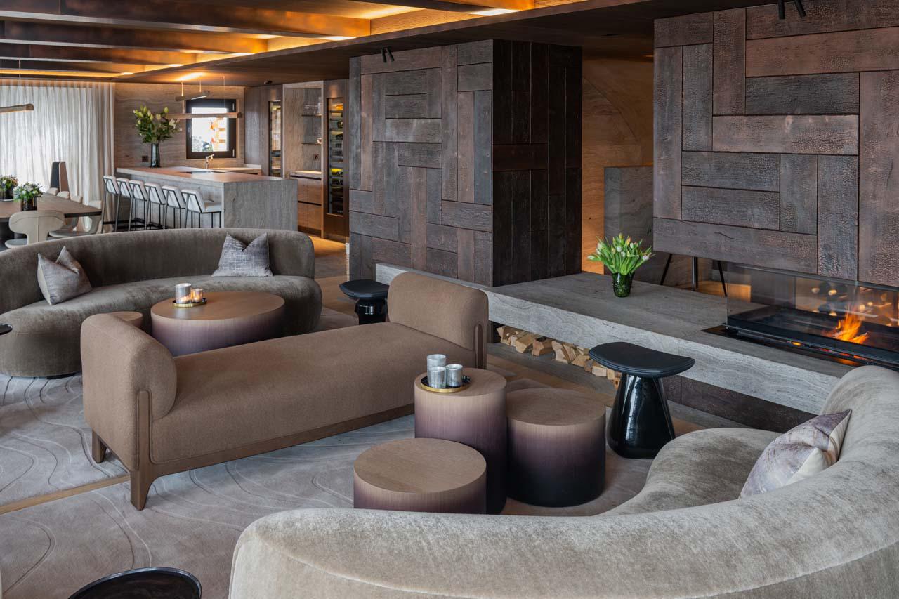 Sofa area with fireplace at Chalet No 14 in Verbier