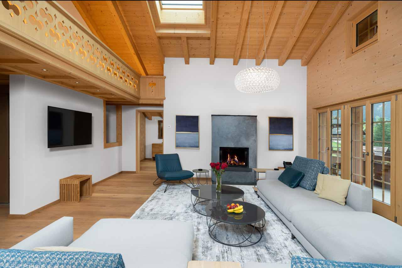 Large top-floor living space with fireplace at Chalet Alia in Grindelwald