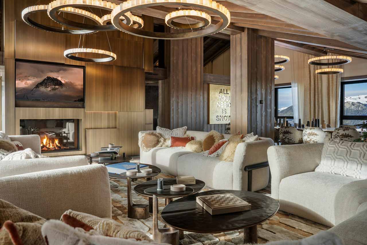 Open-plan living area with sofas in front of fireplace in Atmosphere Penthouse, Courchevel 1850