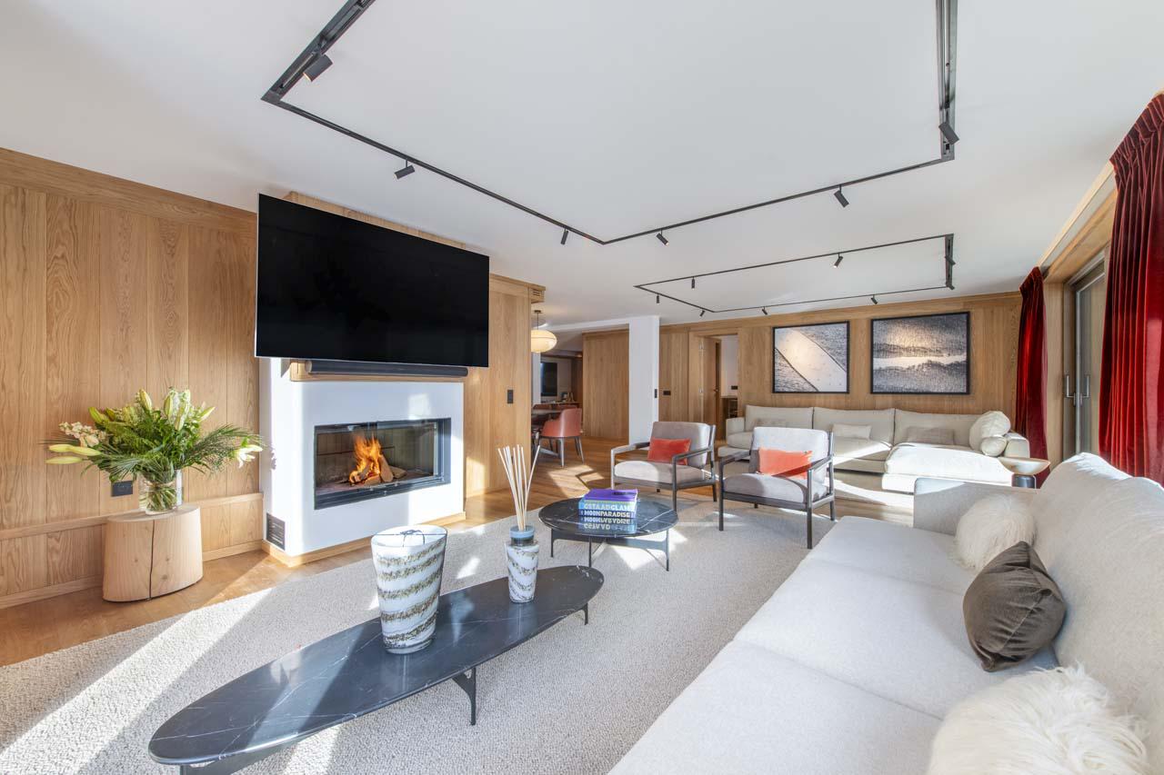 Open-plan living space with sofas, TV, fireplace at Sasha Apartment 4 in Courchevel 1850