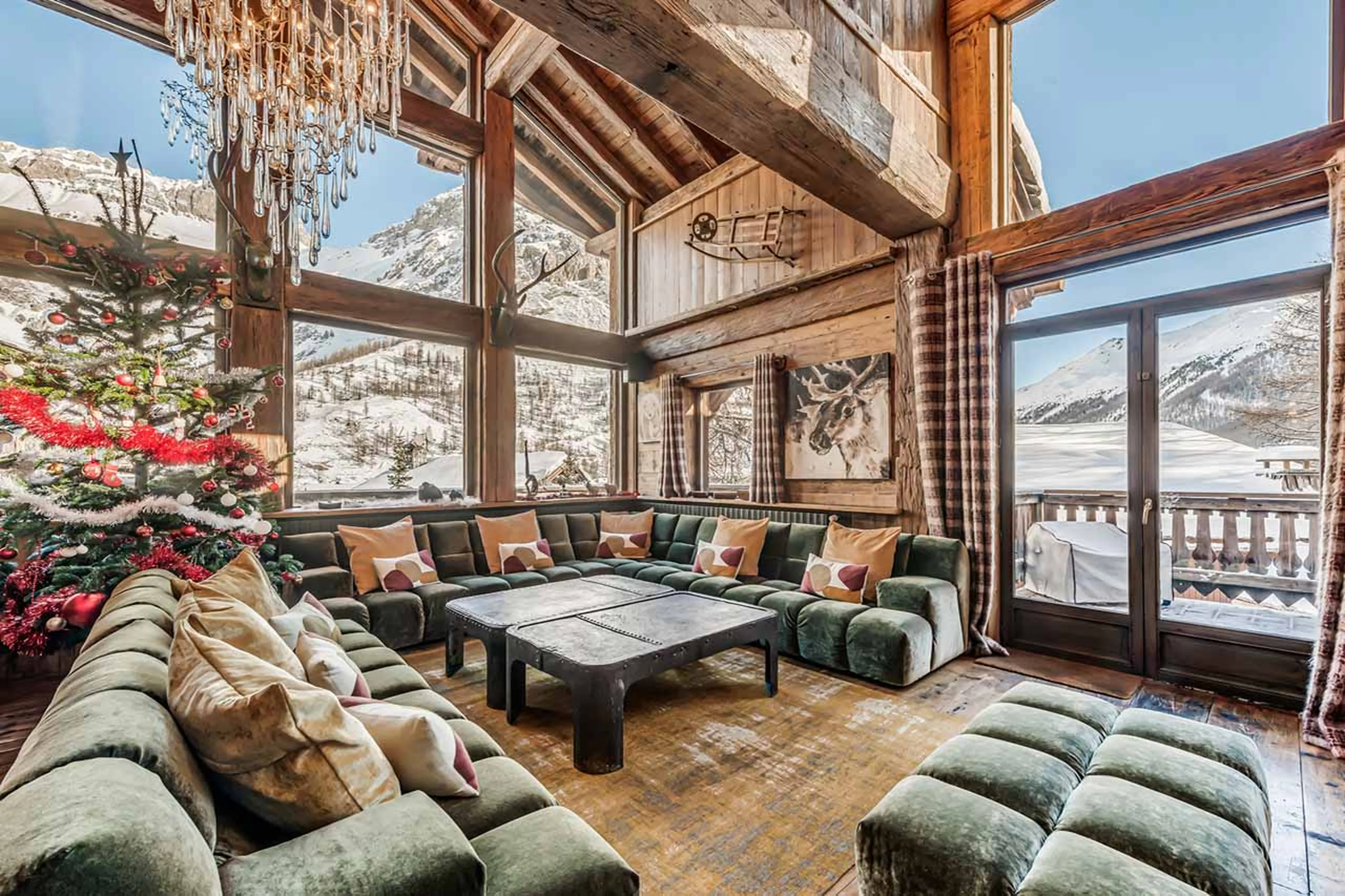 Double height windows in lounge area of Chalet Le Rocher in Val d’Isere