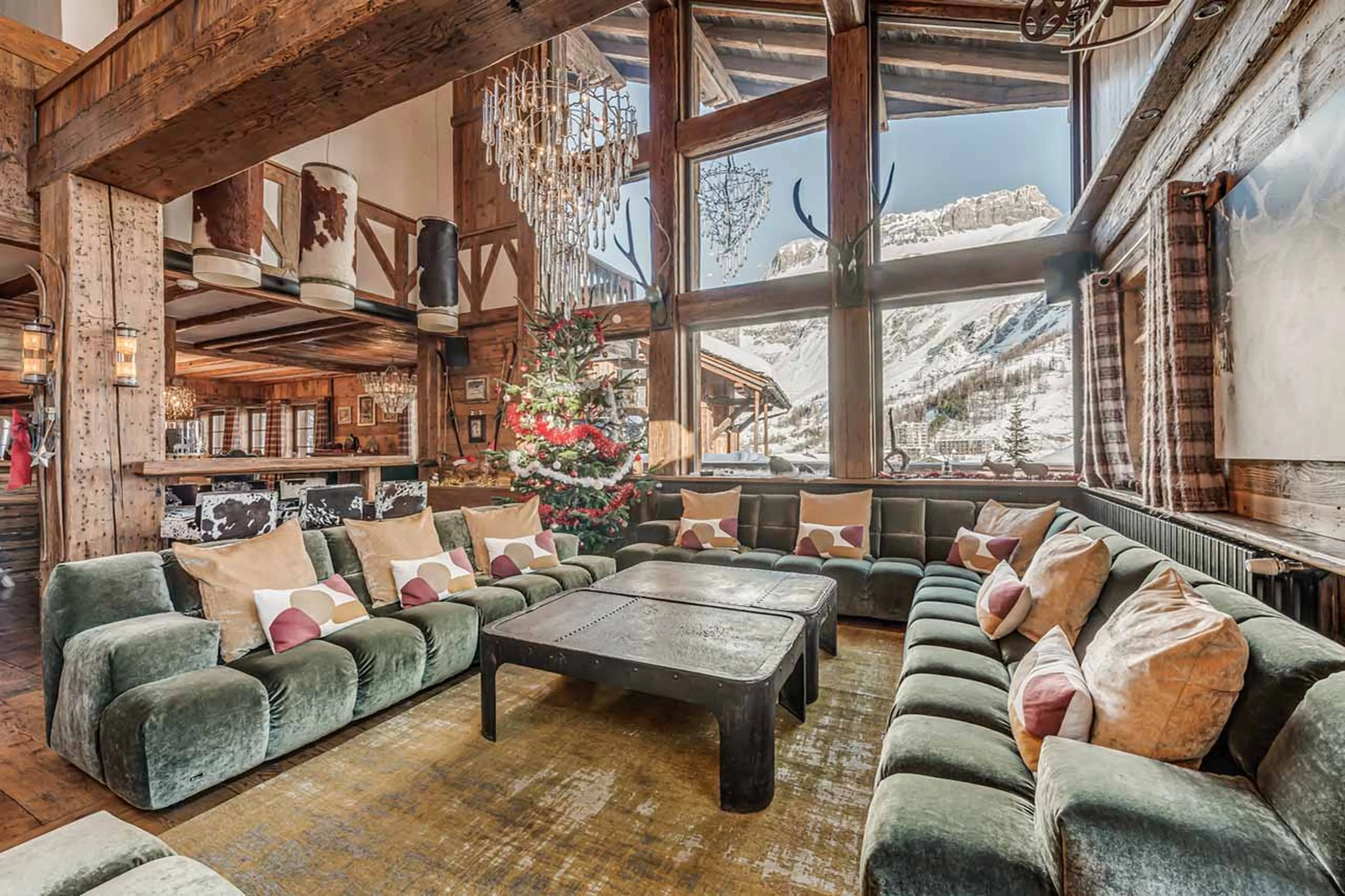 Spacious living area with fireplace and terrace access in Chalet Le Rocher in Val d’Isere