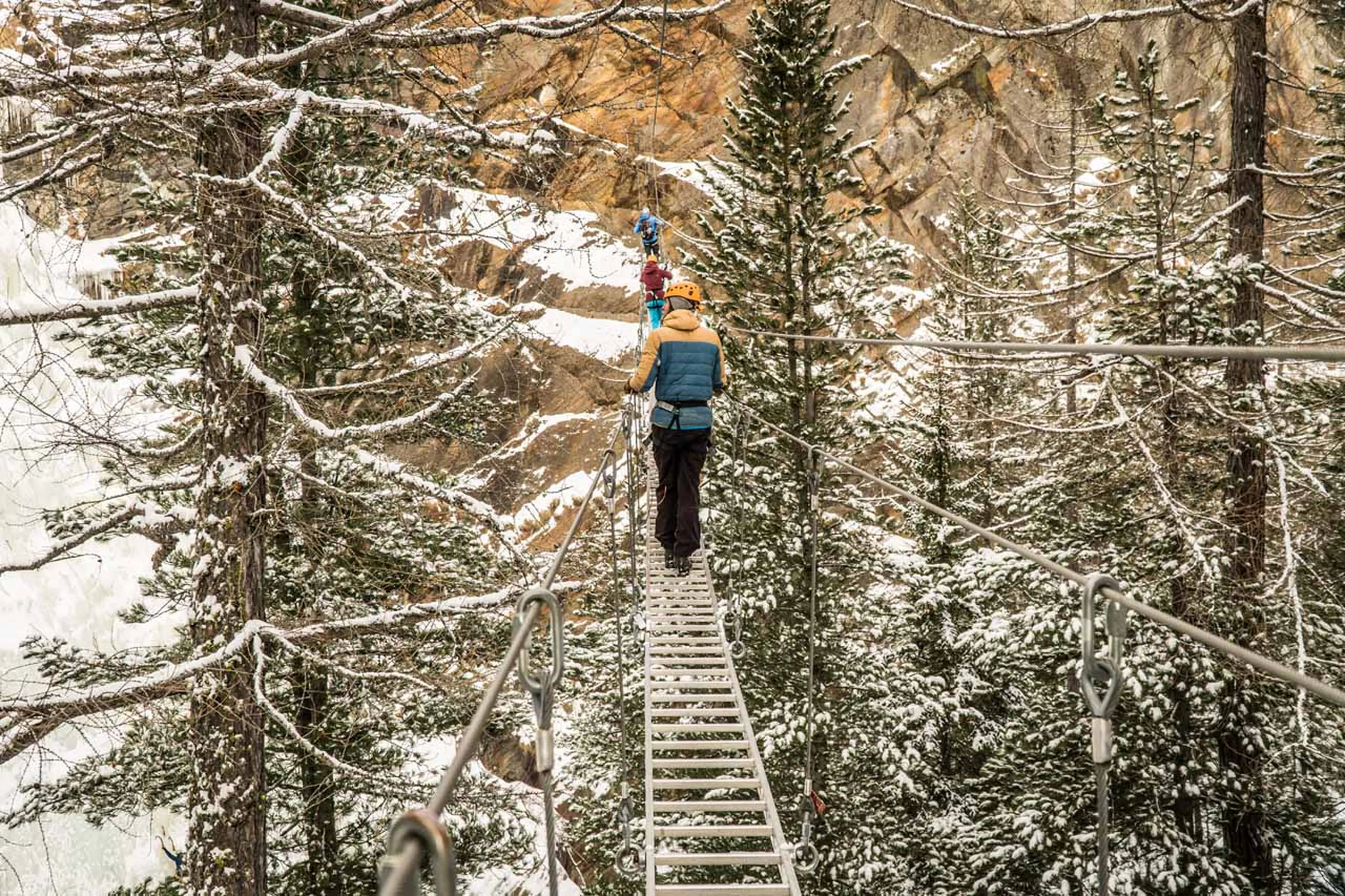 Person walking over a bridge Gorge Alpine Winter Saas-Fee