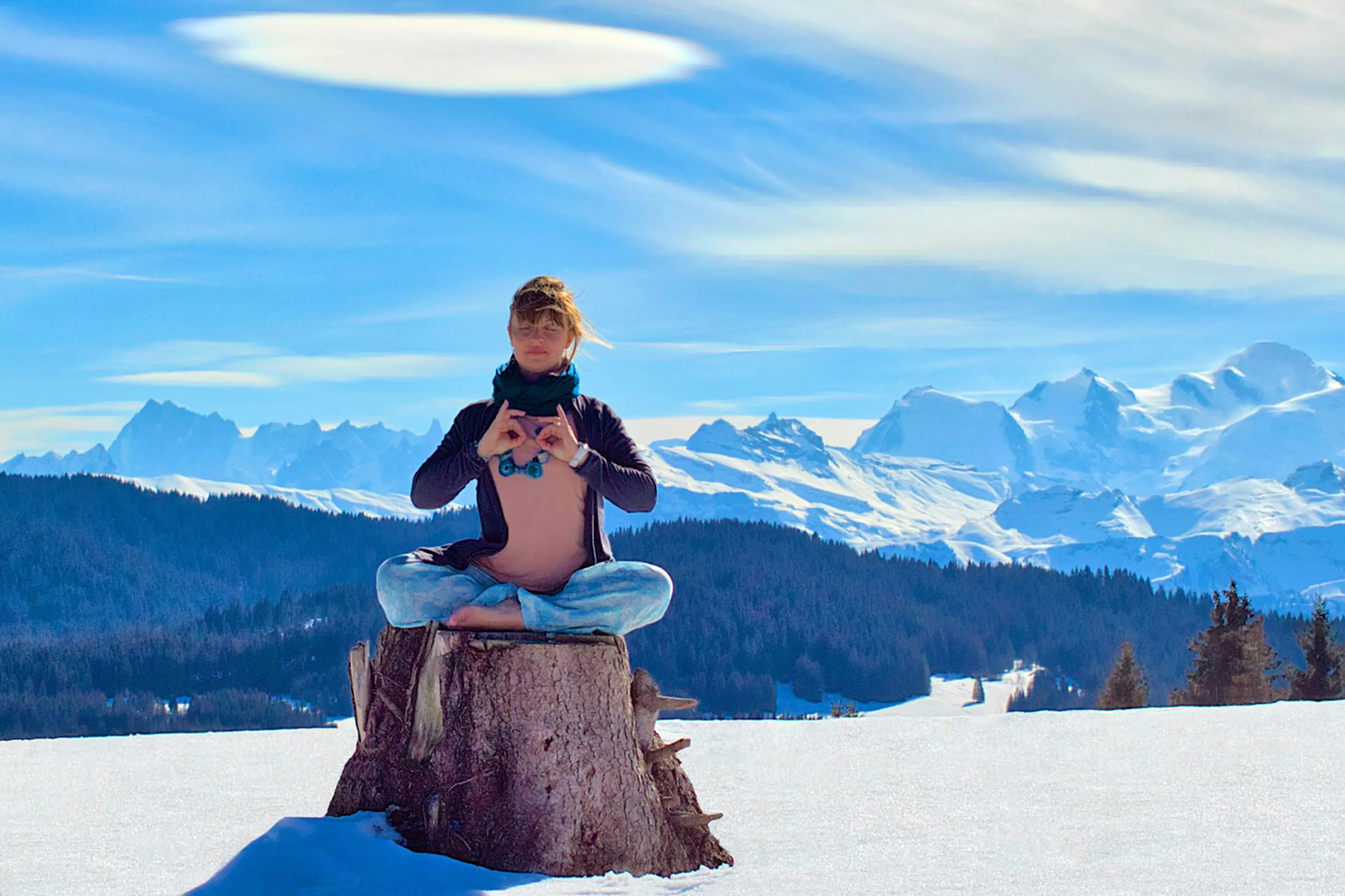 Woman doing yoga in front of the mountains les gets