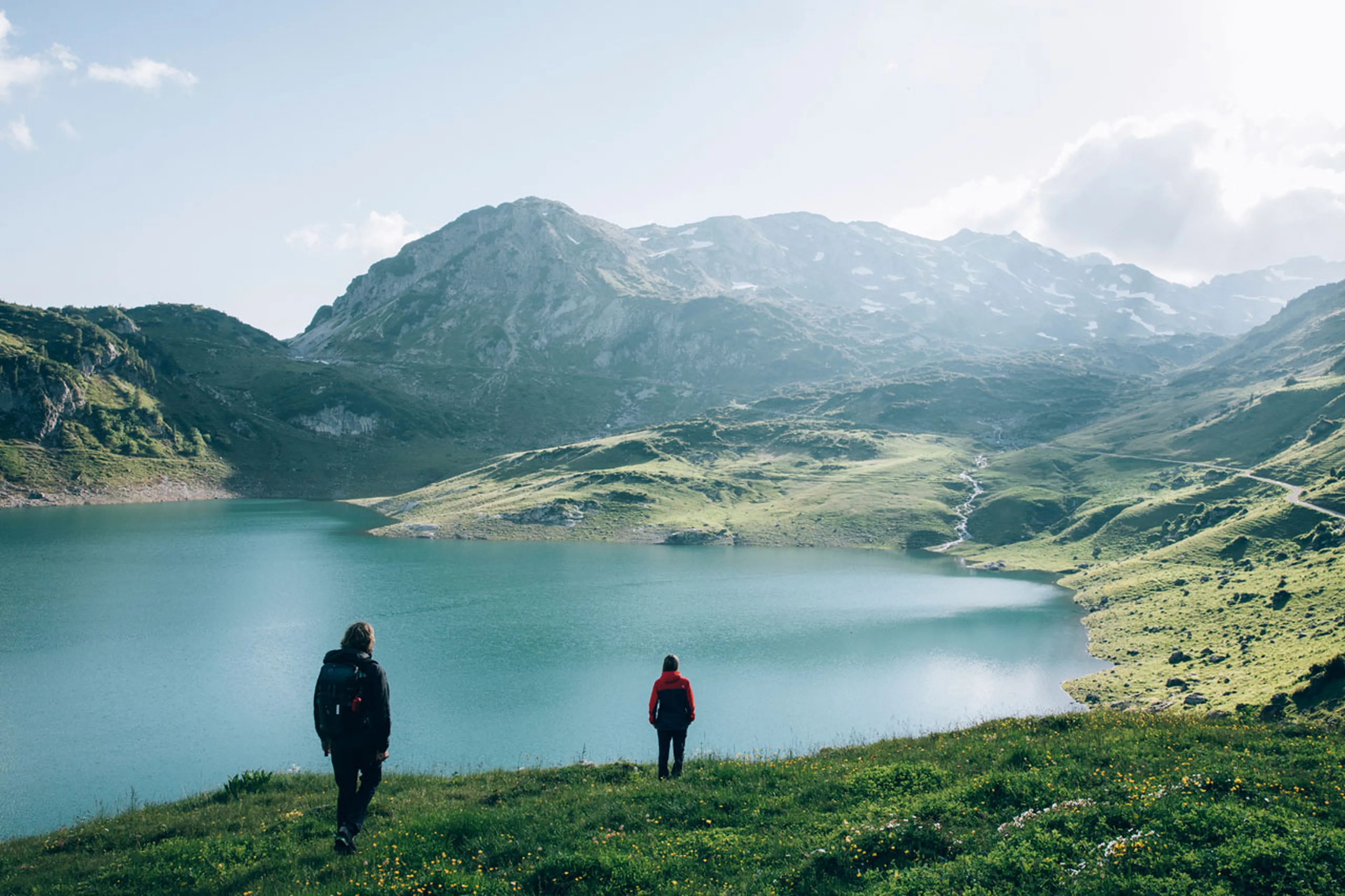 Two people walking near lake in Austria