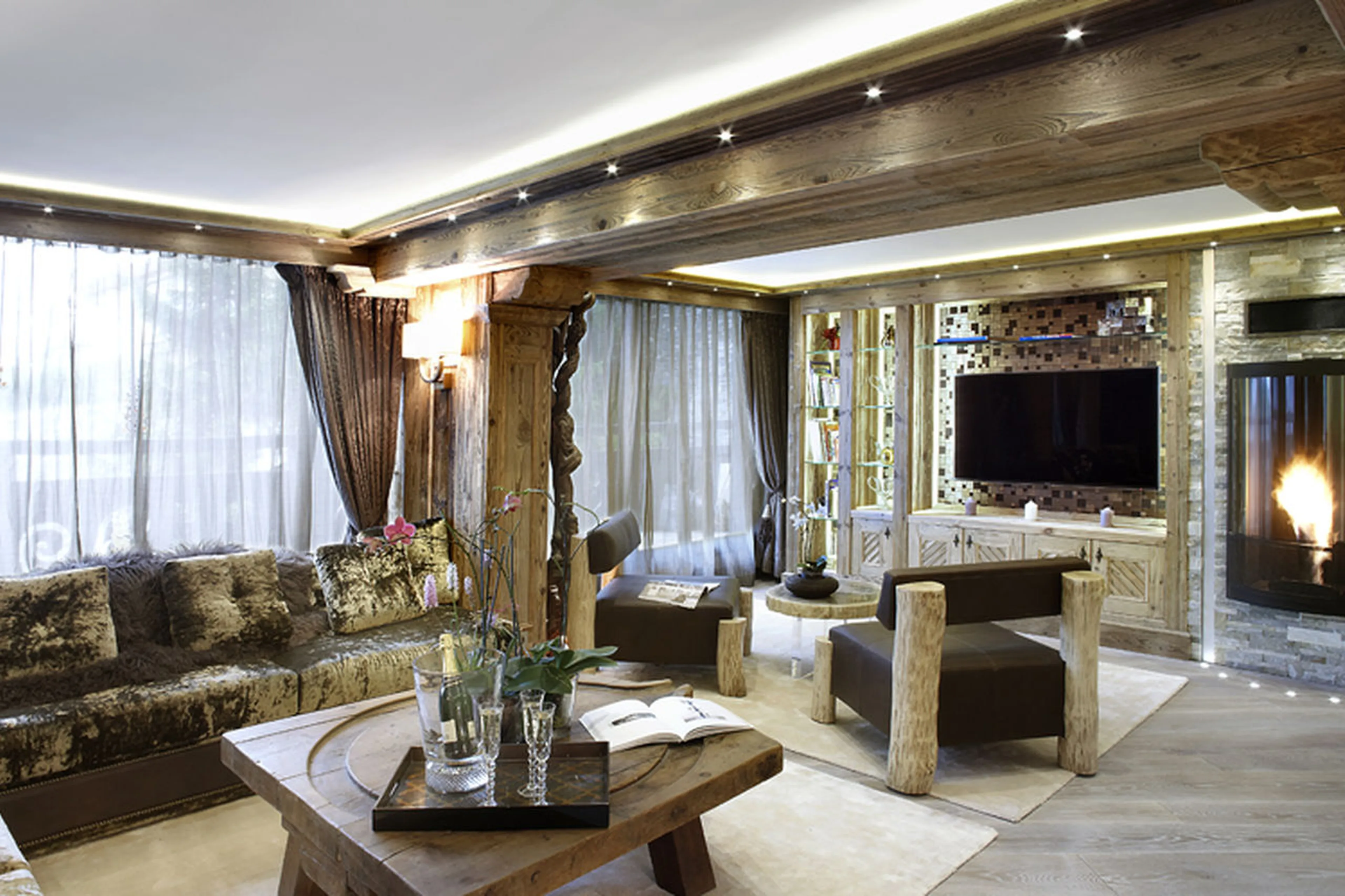 Comfortable sofas in front of wood-burning stove in Apartment Albaron in Courchevel 1850