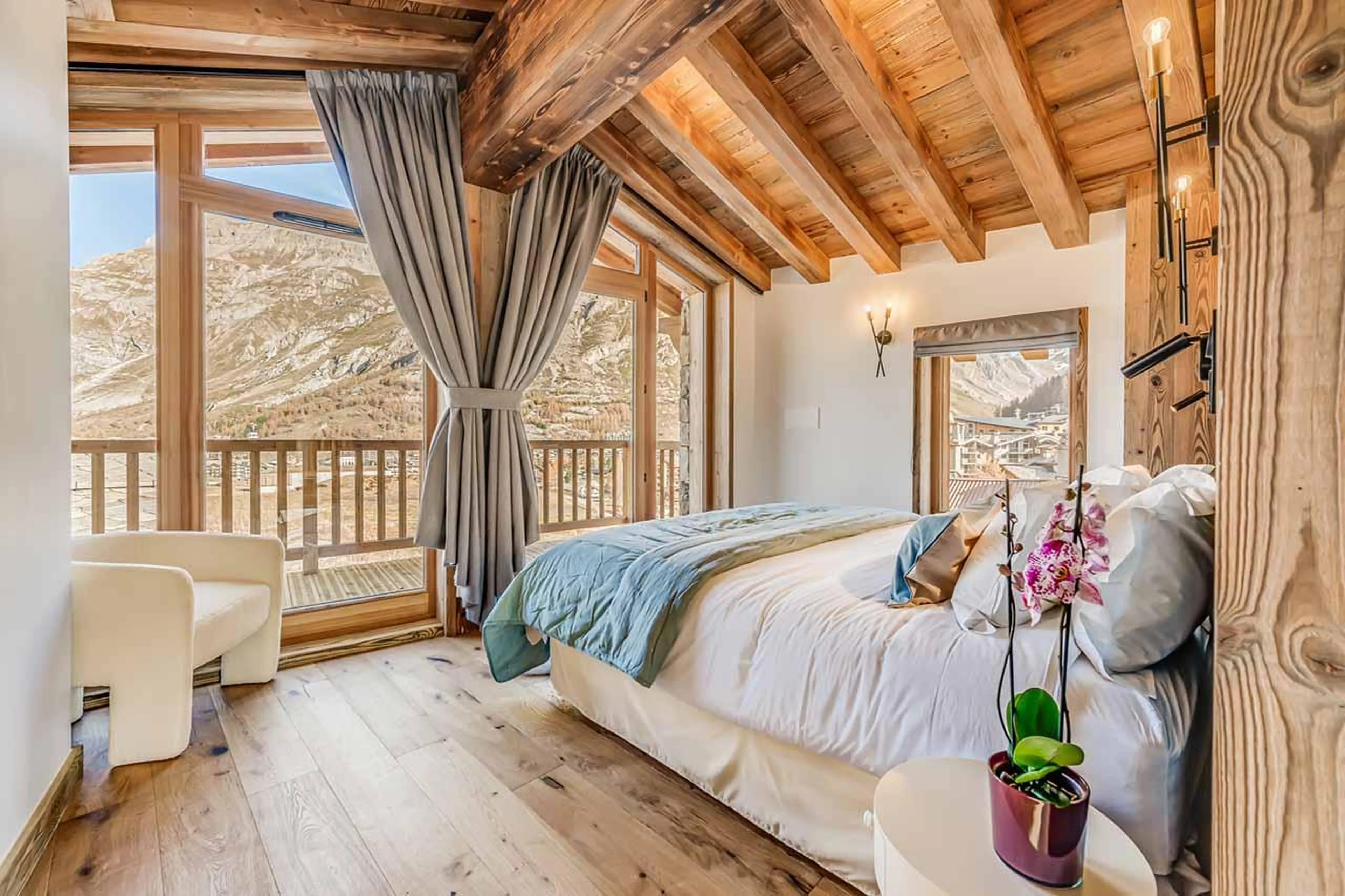 Double bedroom with vaulted windows and glass doors in Apartment Aurora, Val d'Isere