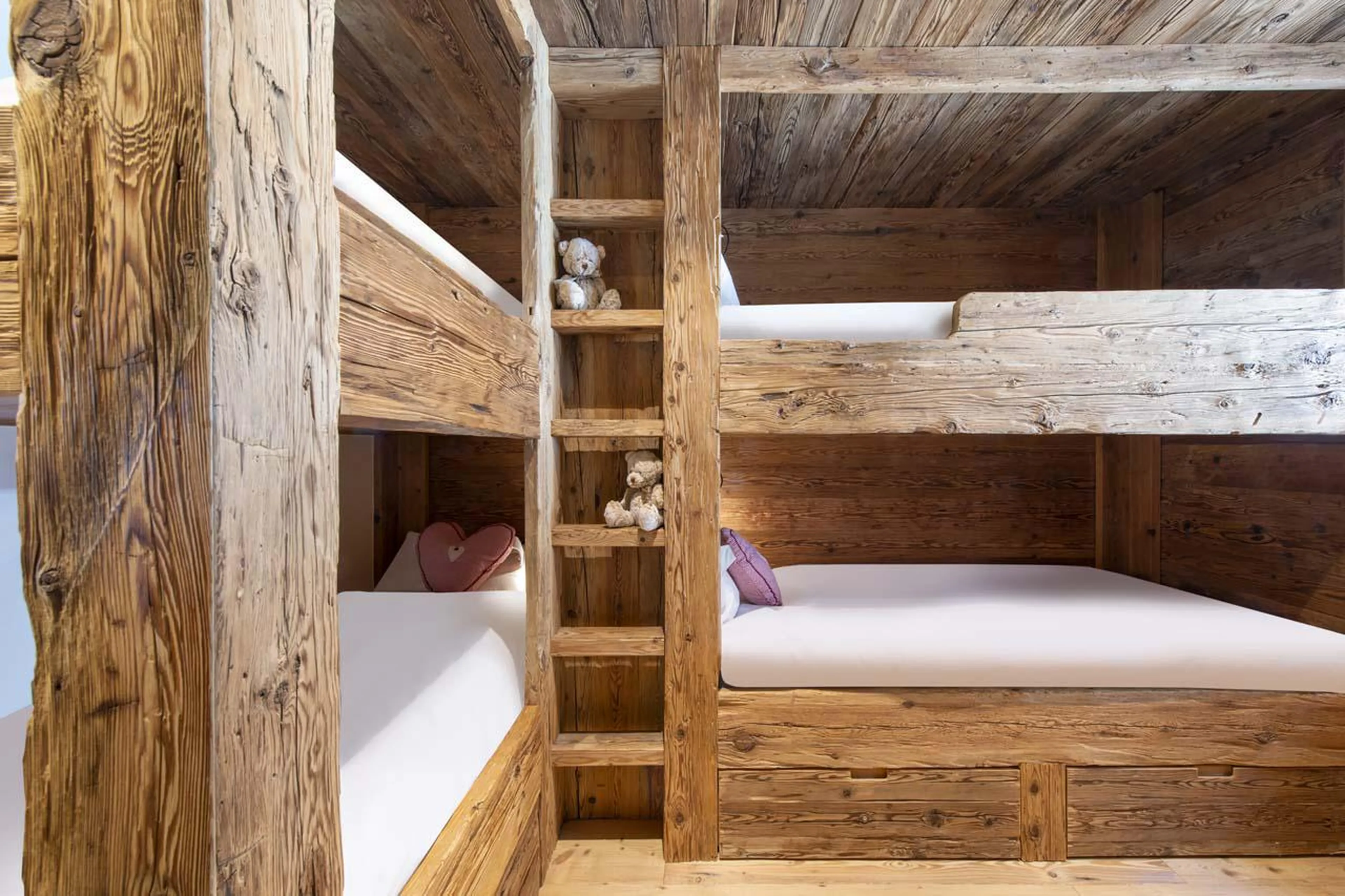 Quad bunk bedroom with a TV and separate shower room at Apartment Basalte C13 in Verbier