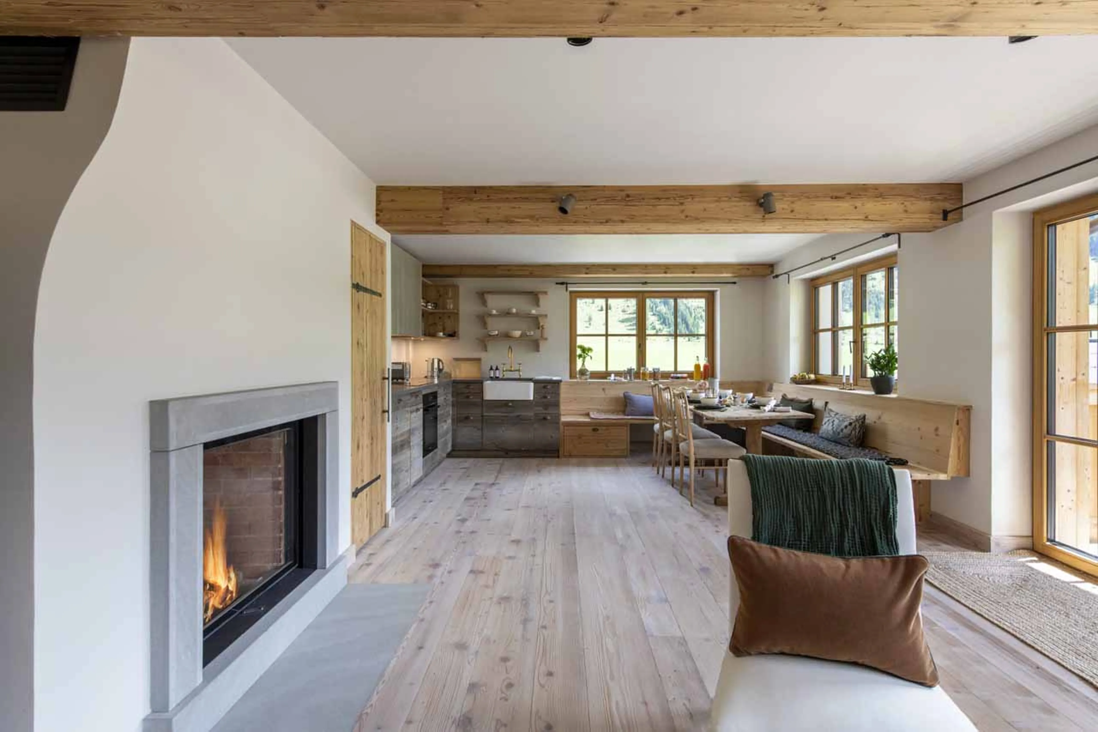 Fireplace dividing living area from dining area at Apartment Brunnenhof 8 in Lech