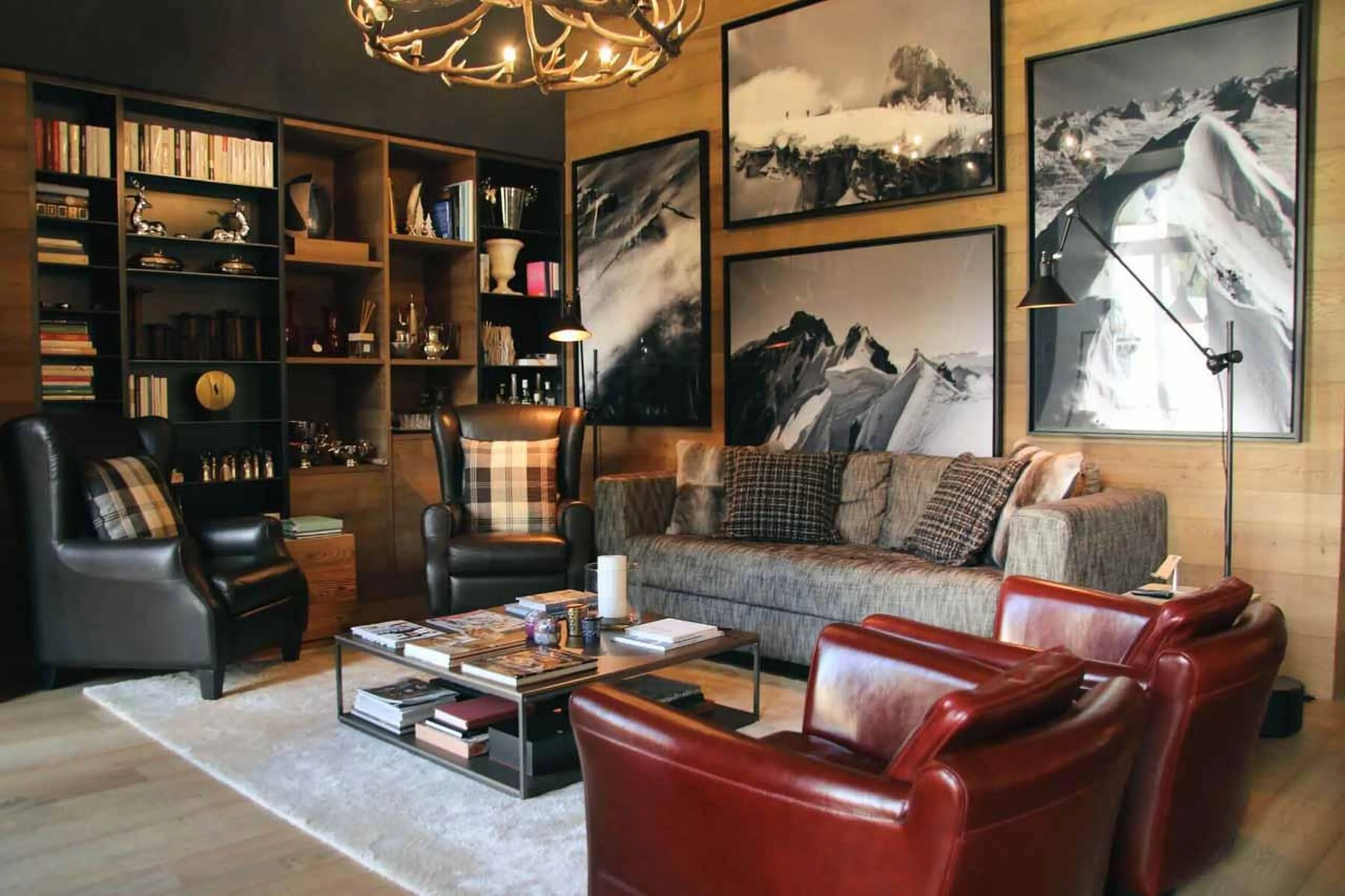 Sofas, armchairs and bookshelf in Apartment Lain Alpin, St Moritz