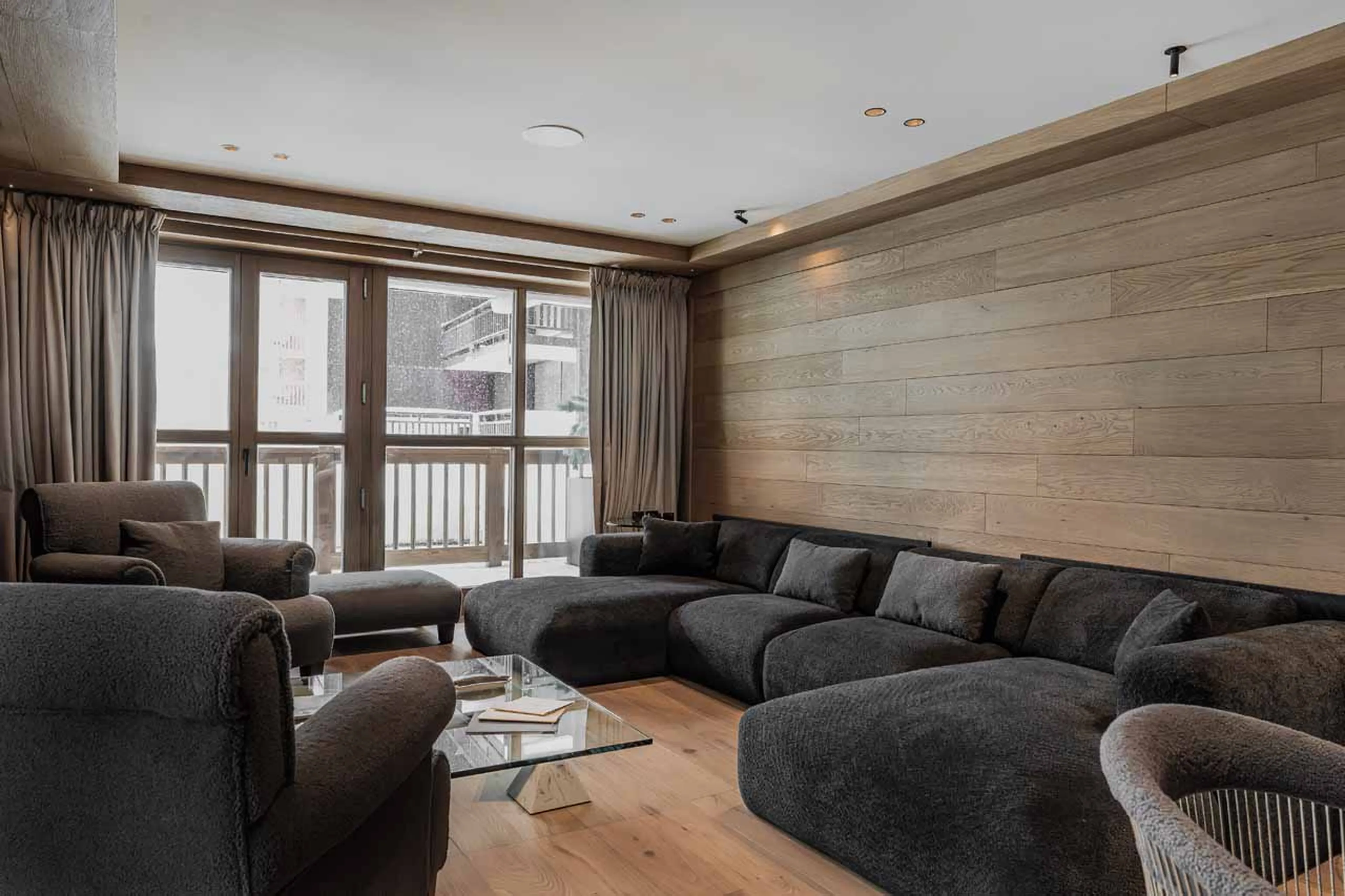 Sofa facing TV and French doors in Le Cinq, Val d'Isere