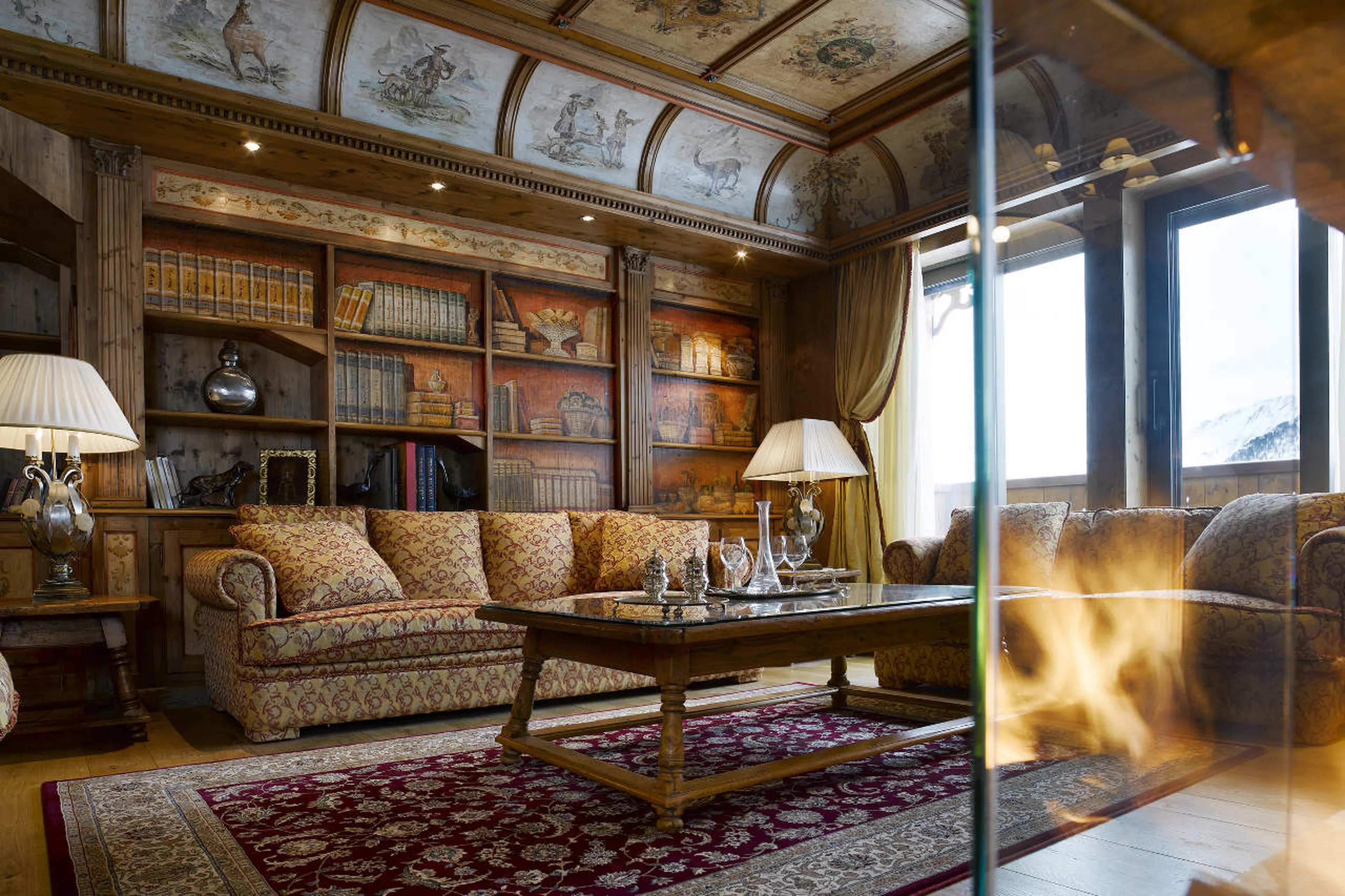Living area with central fireplace in Apartment Le Sommet in Courchevel 1850