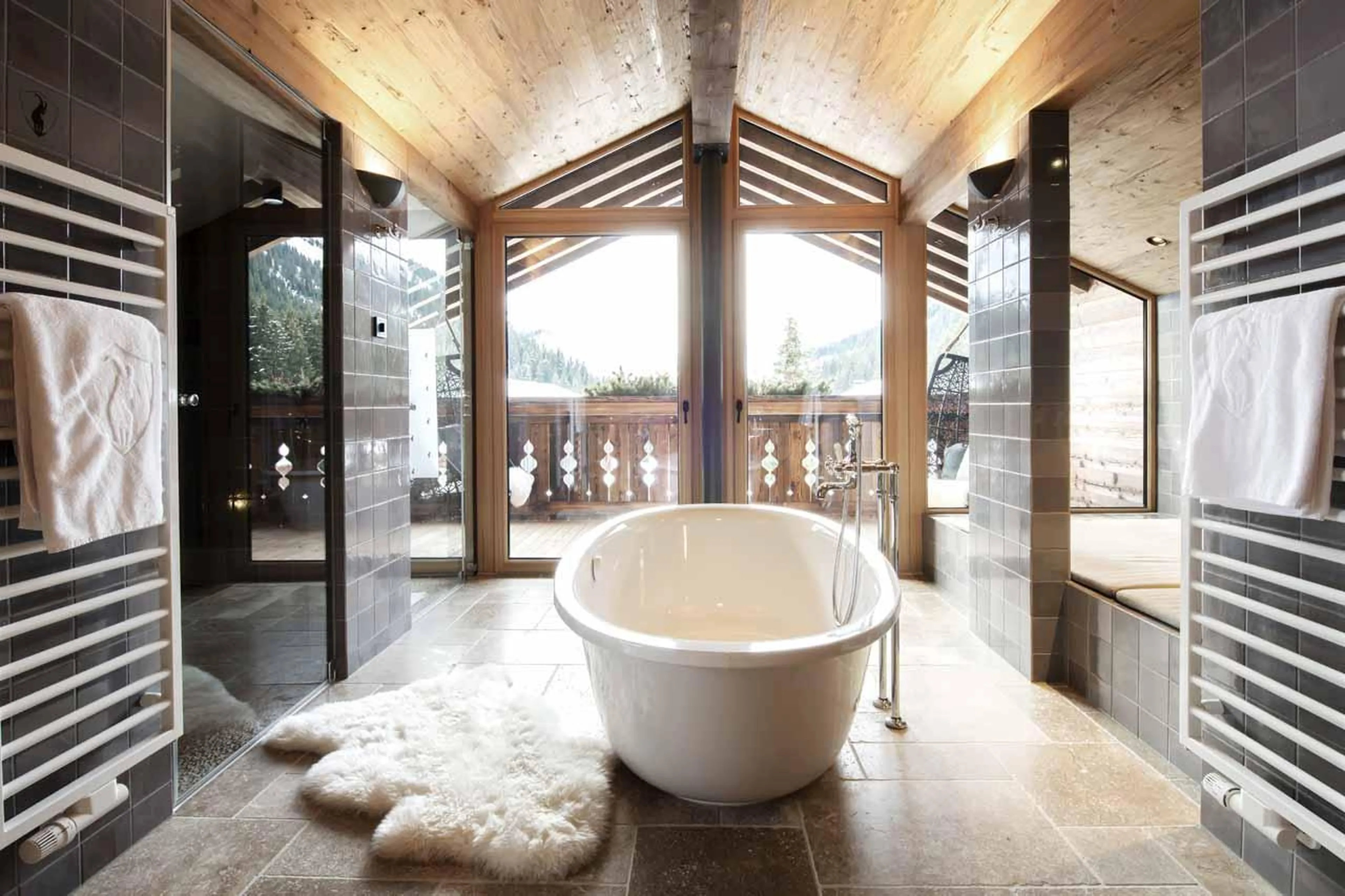 Freestanding bathtub beneath vaulted windows in Apartment Lech II, Lech