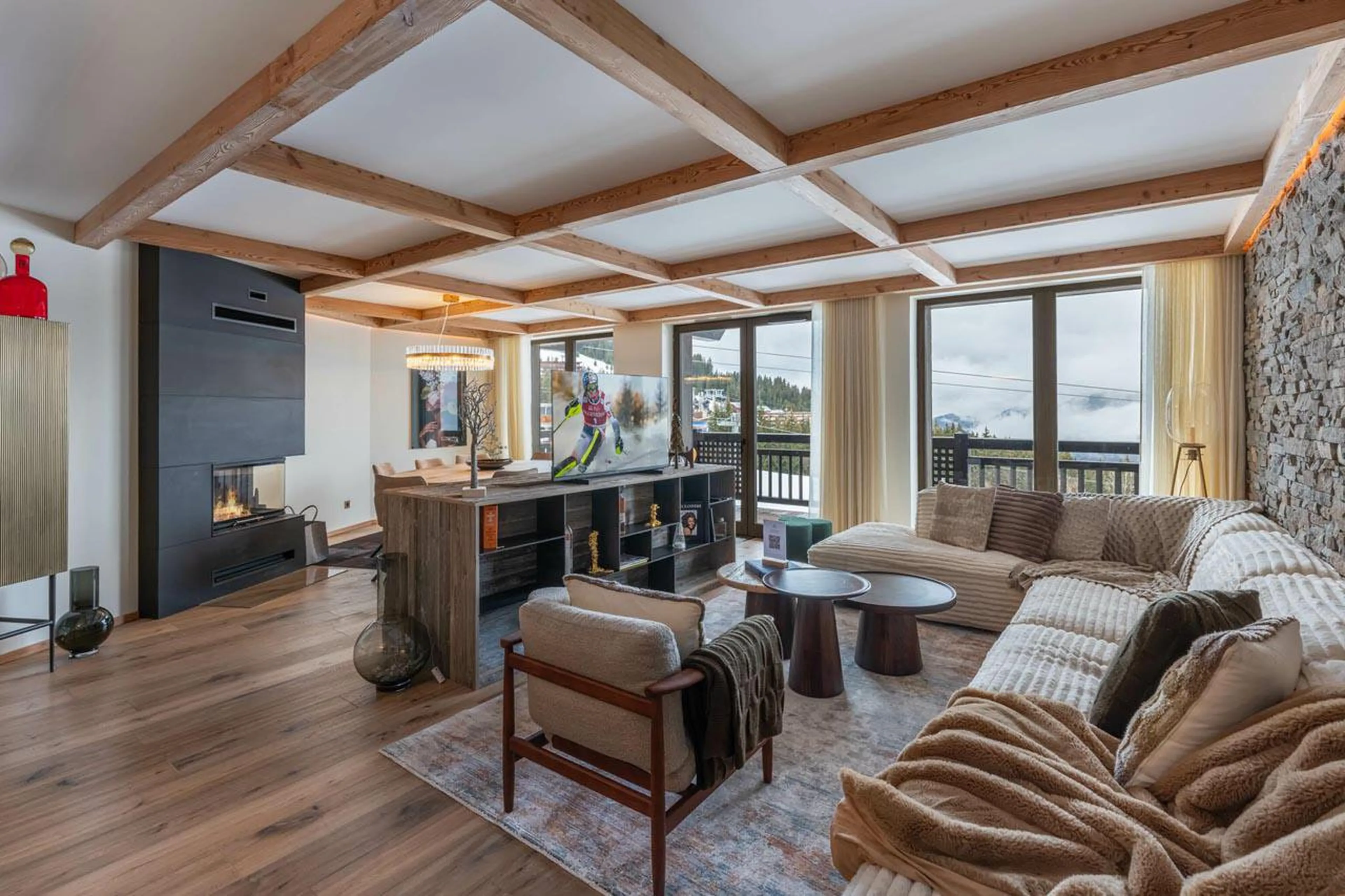 Living area with contemporary feel and corner fireplace at Apartment Michaelo in Courchevel 1850
