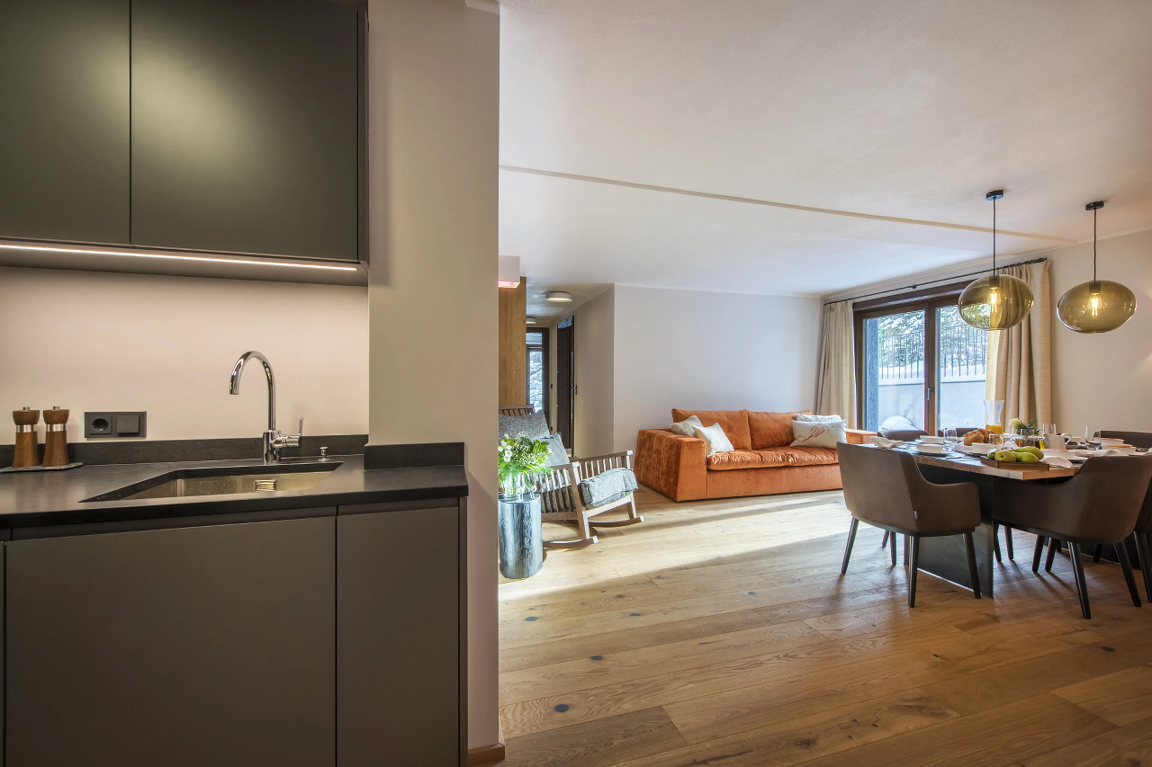 Open-plan kitchen’s view on living and dining area in Apartment 1 in Lech