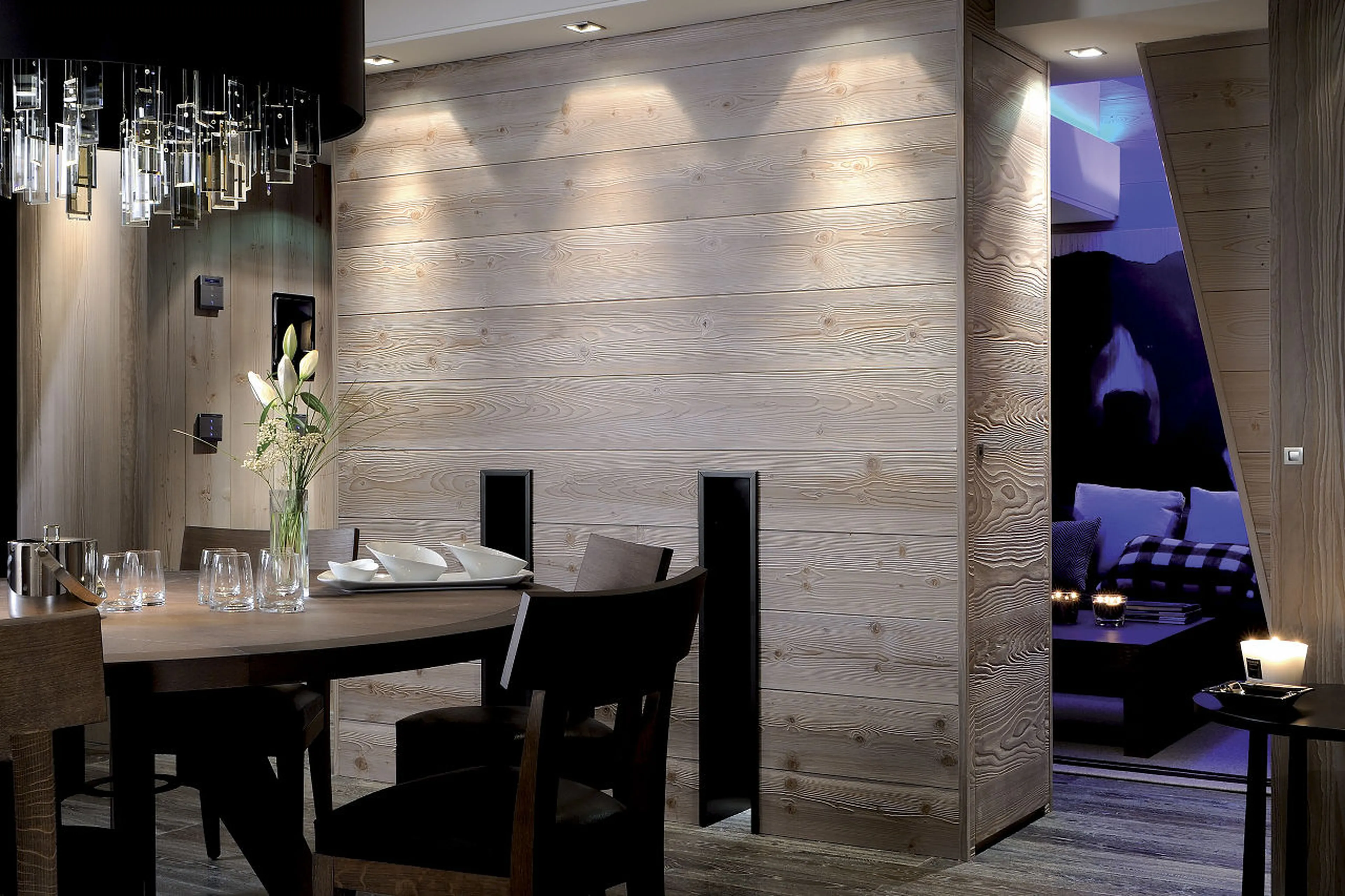 Soft light from chandelier above table in dining room of Apartment Onyx in Courchevel 1850
