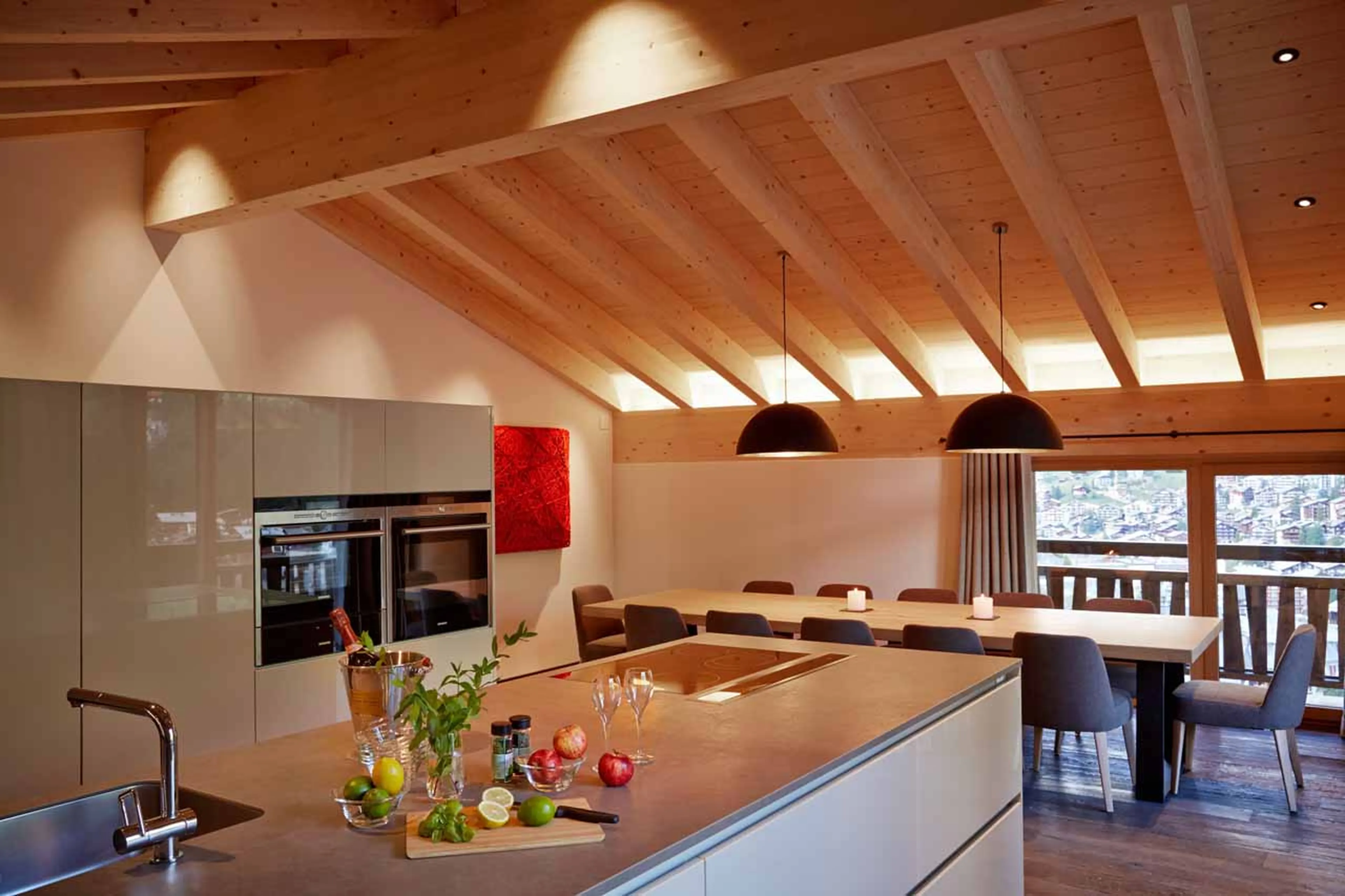 Dining table and kitchen island at Apartment Panorama in Zermatt
