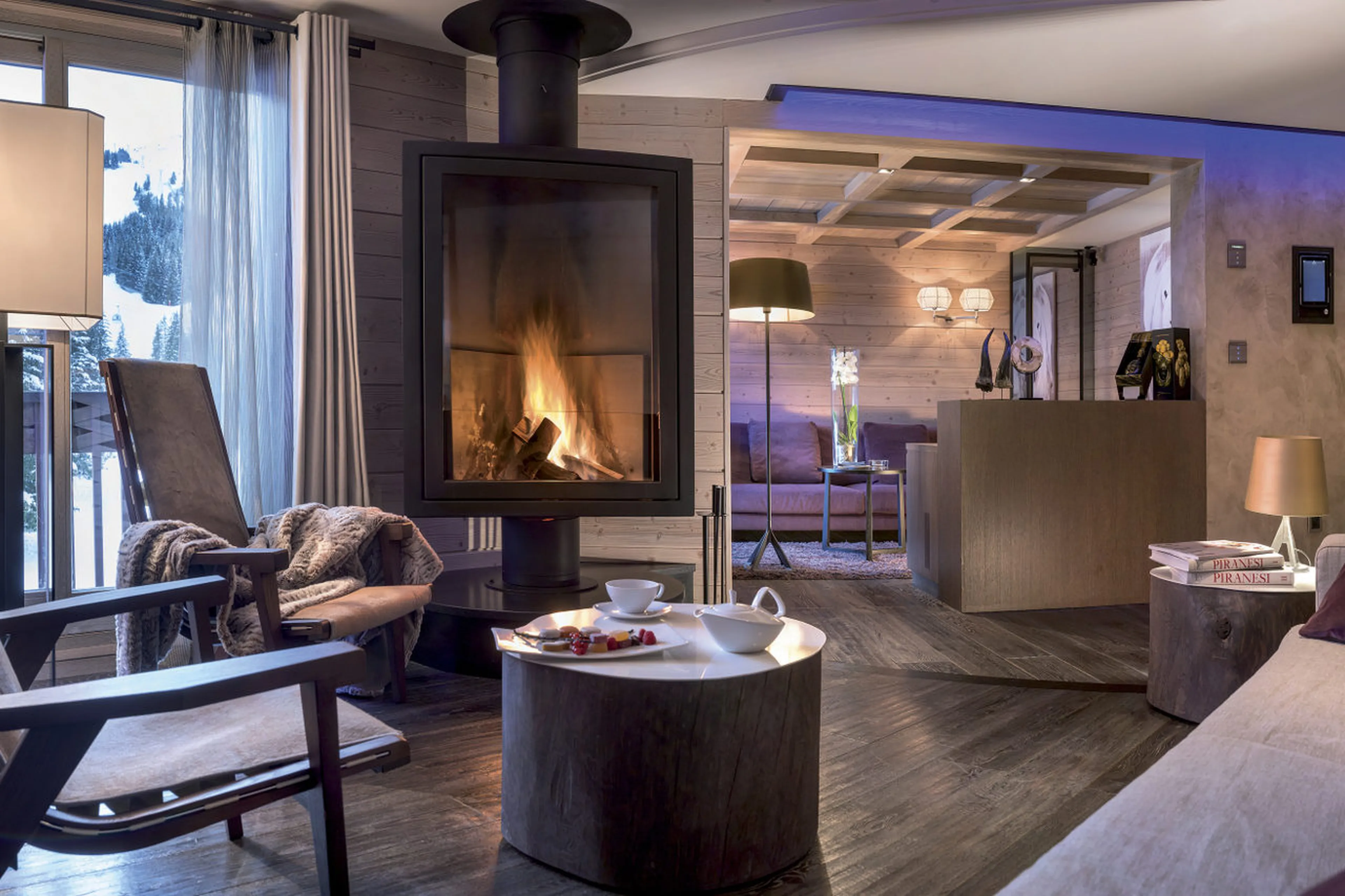 Cosy fireplace on one side of south facing living room in Apartment Serpentine in Courchevel 1850
