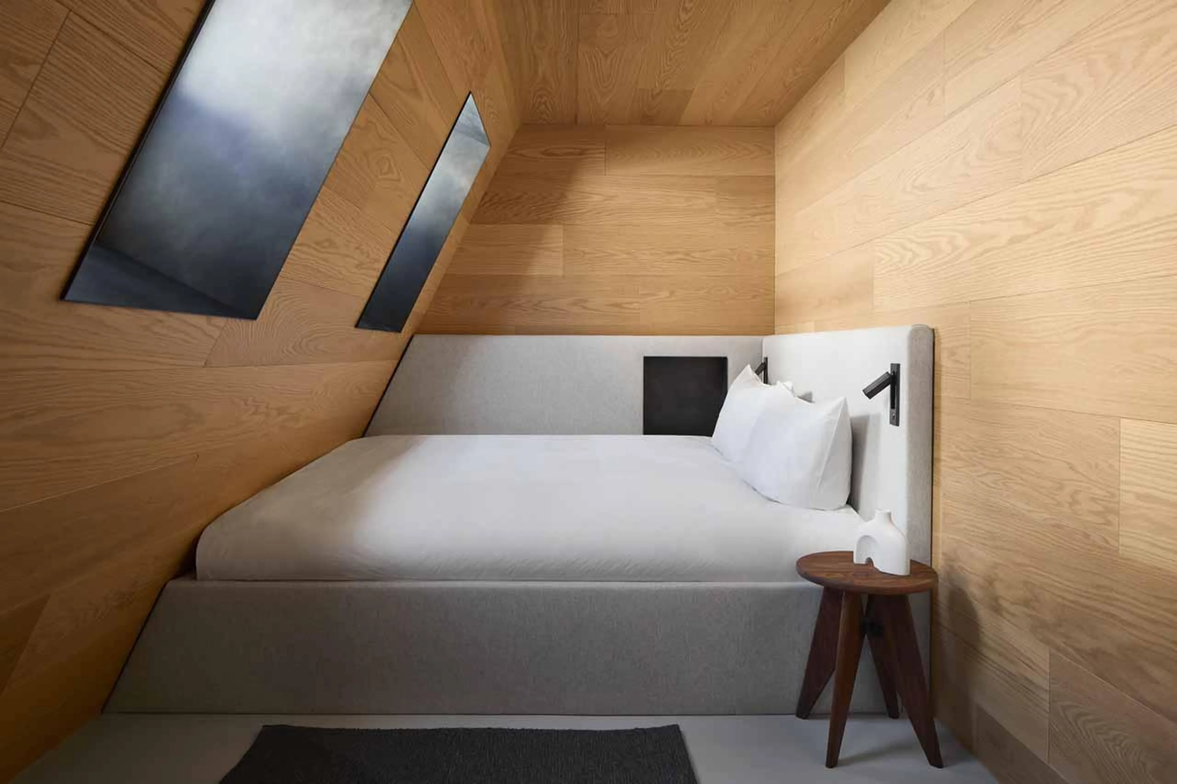 Double bed up against wall in Cabane Tortin, Verbier