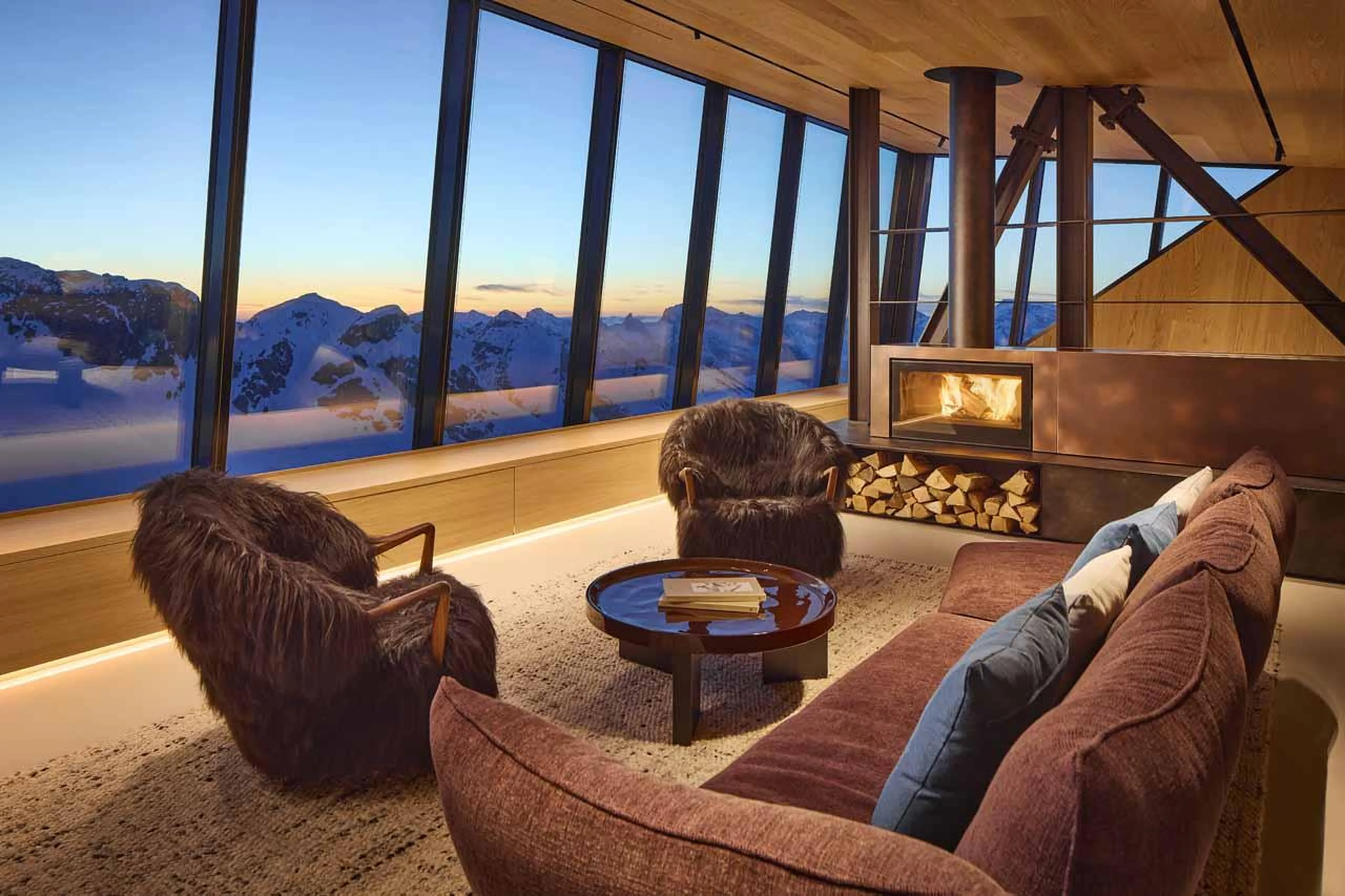 Living area with sofas and fireplace in Cabane Tortin, Verbier