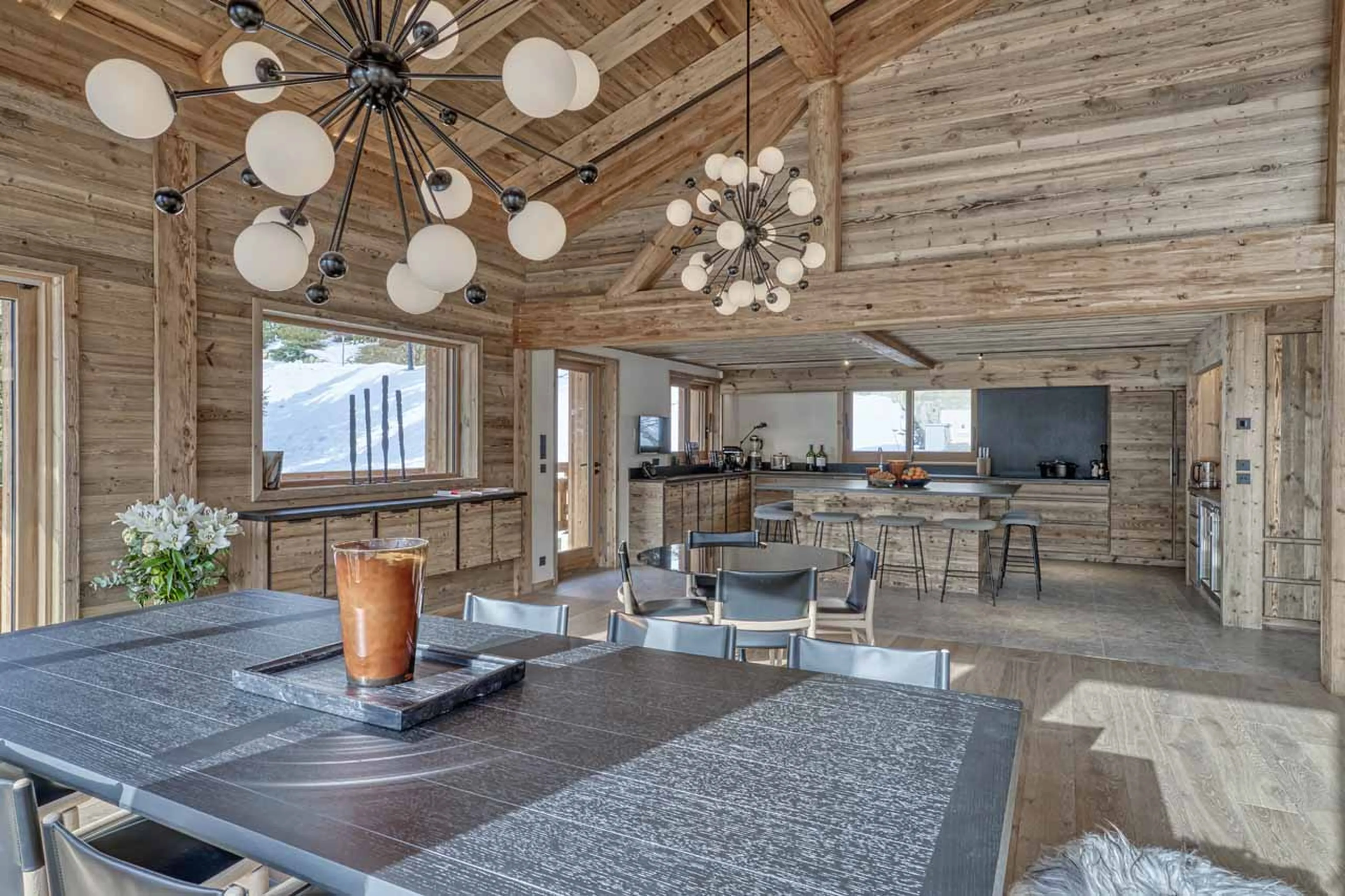 Dining table and kitchen at Chalet 141 in Megeve