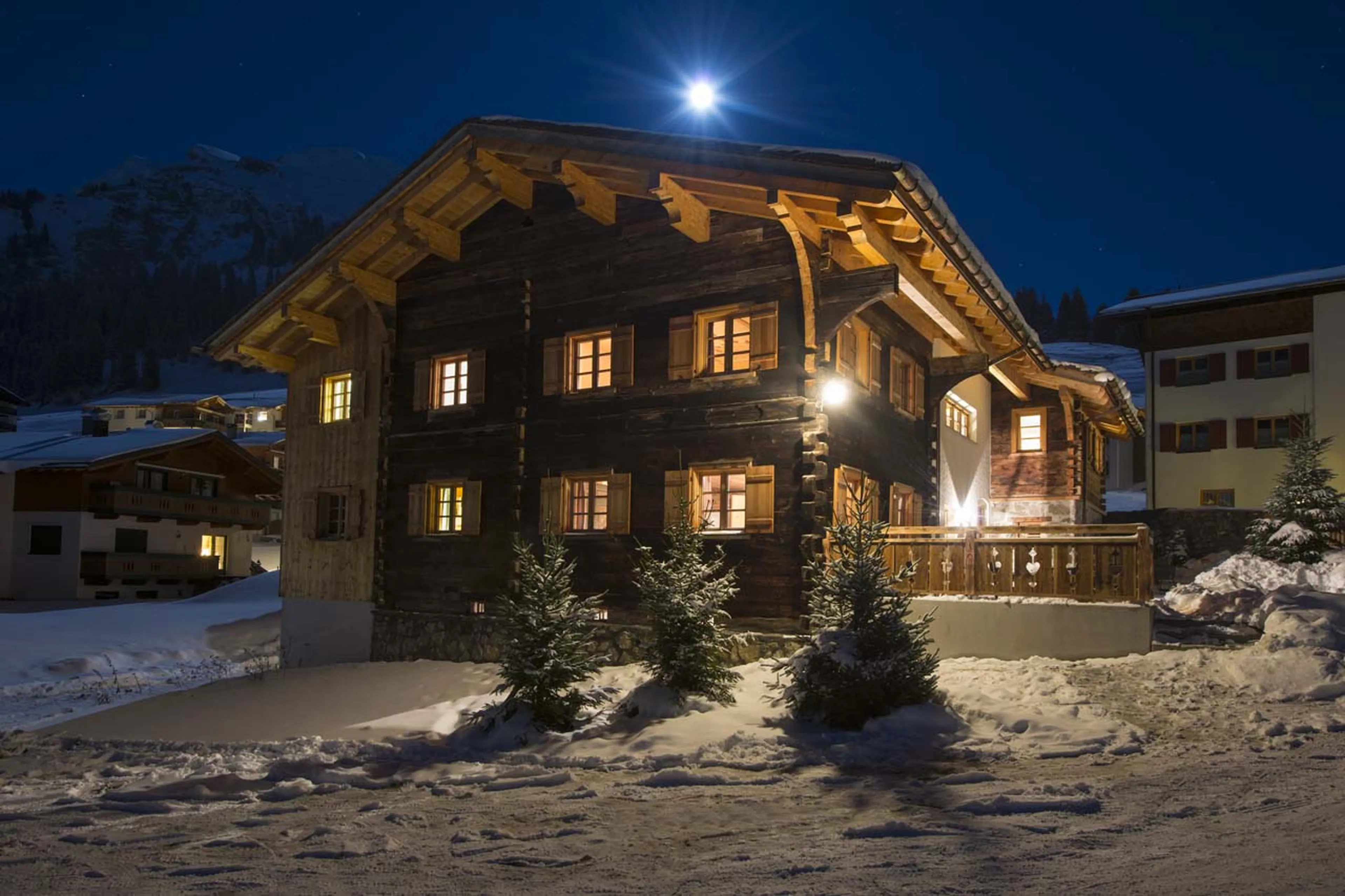 Romantic night time view of traditional renovated Chalet 1597 in Lech