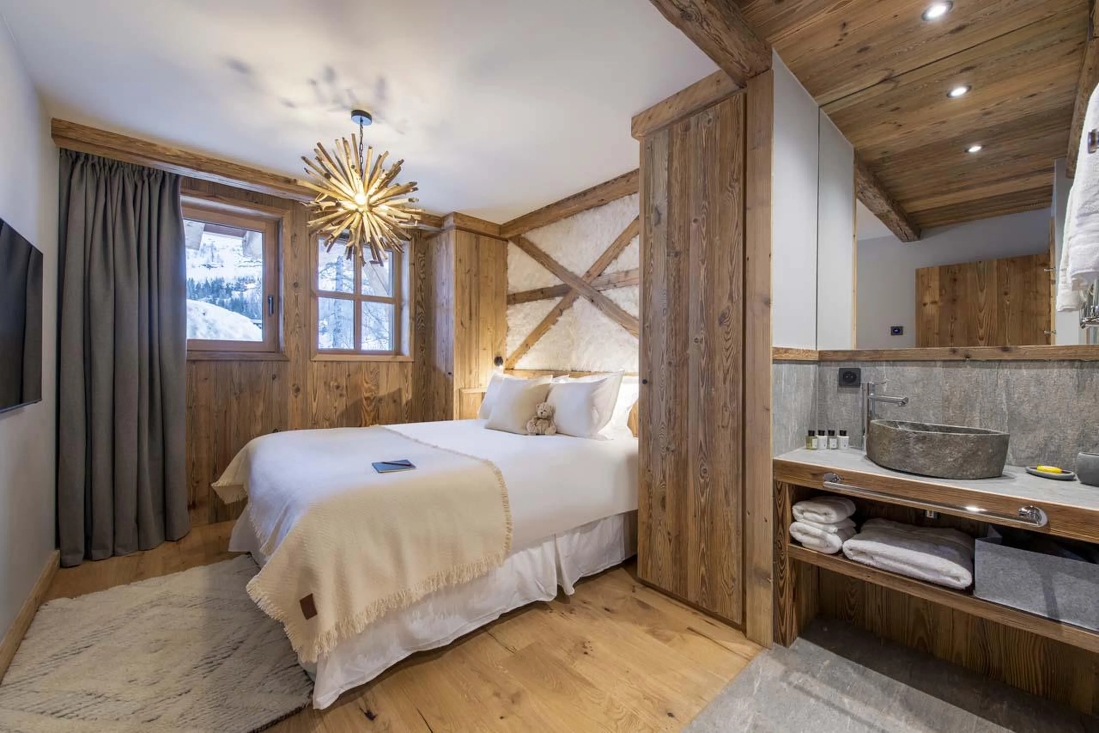 Double bedroom with TV and en-suite shower at Chalet 1855 in Val d'Isere