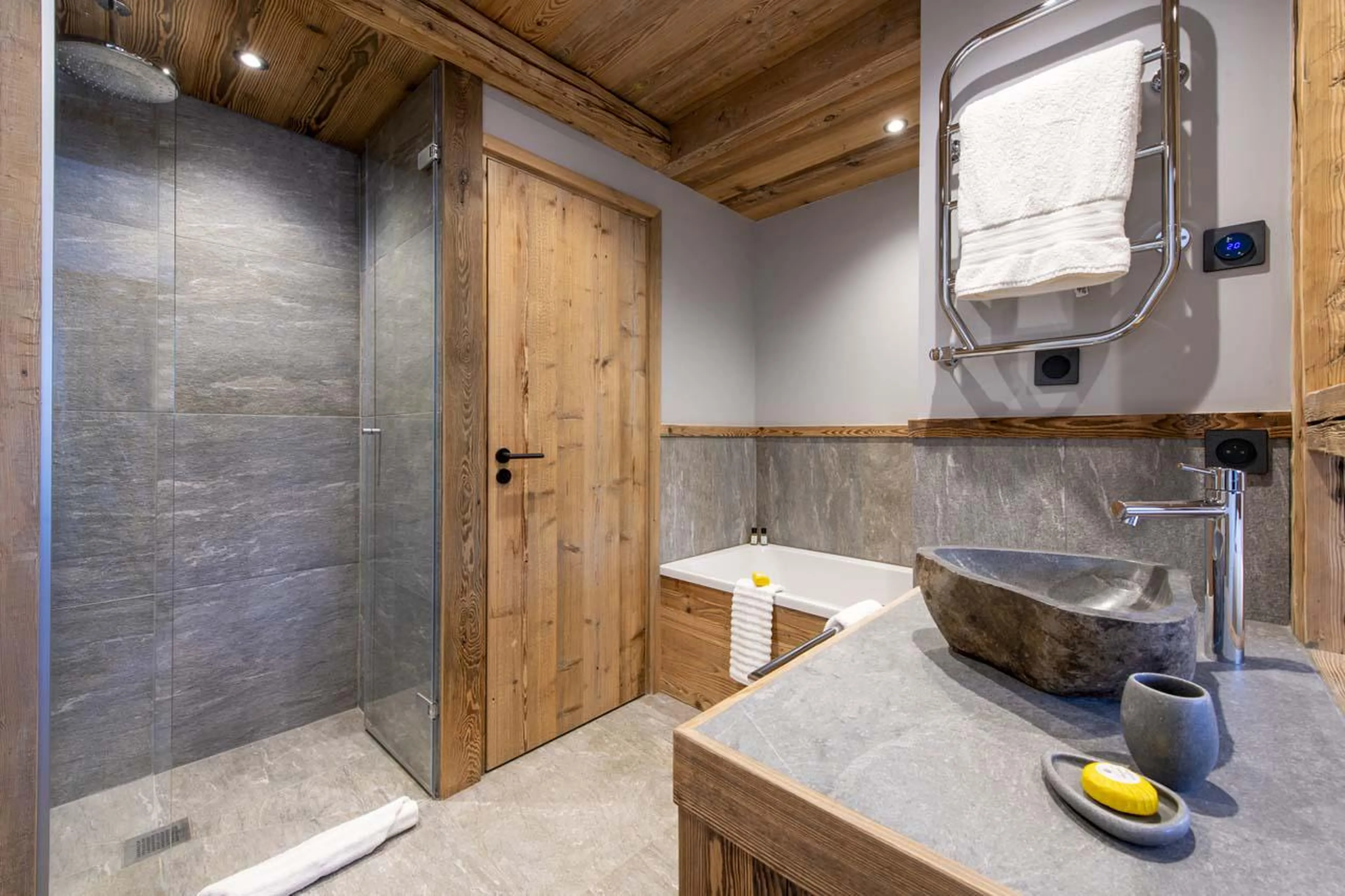 En-suite bathroom with bath and shower at Chalet 1855 in Val d'Isere