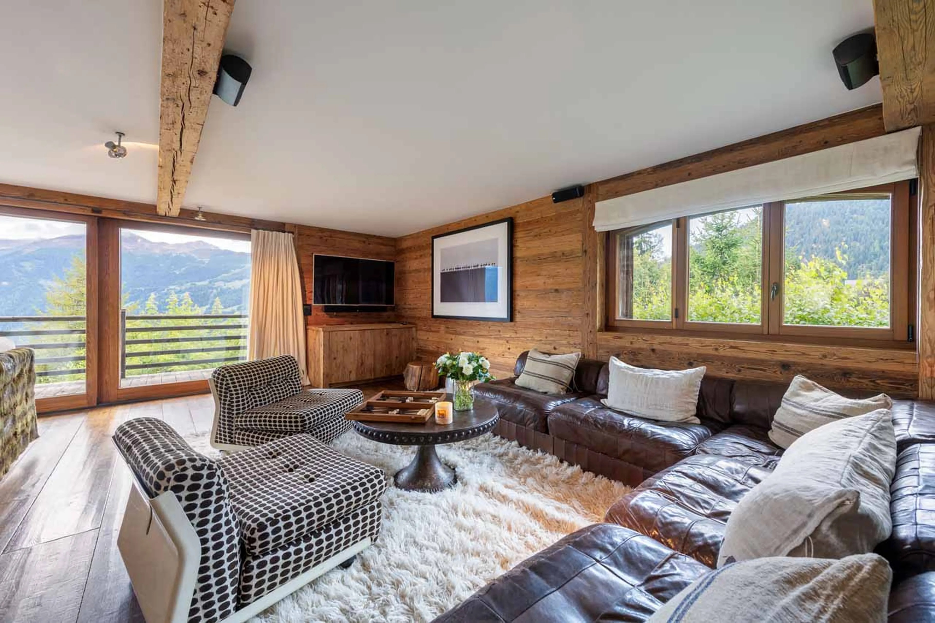 Open plan living area with terrace access at Chalet 1936 in Verbier