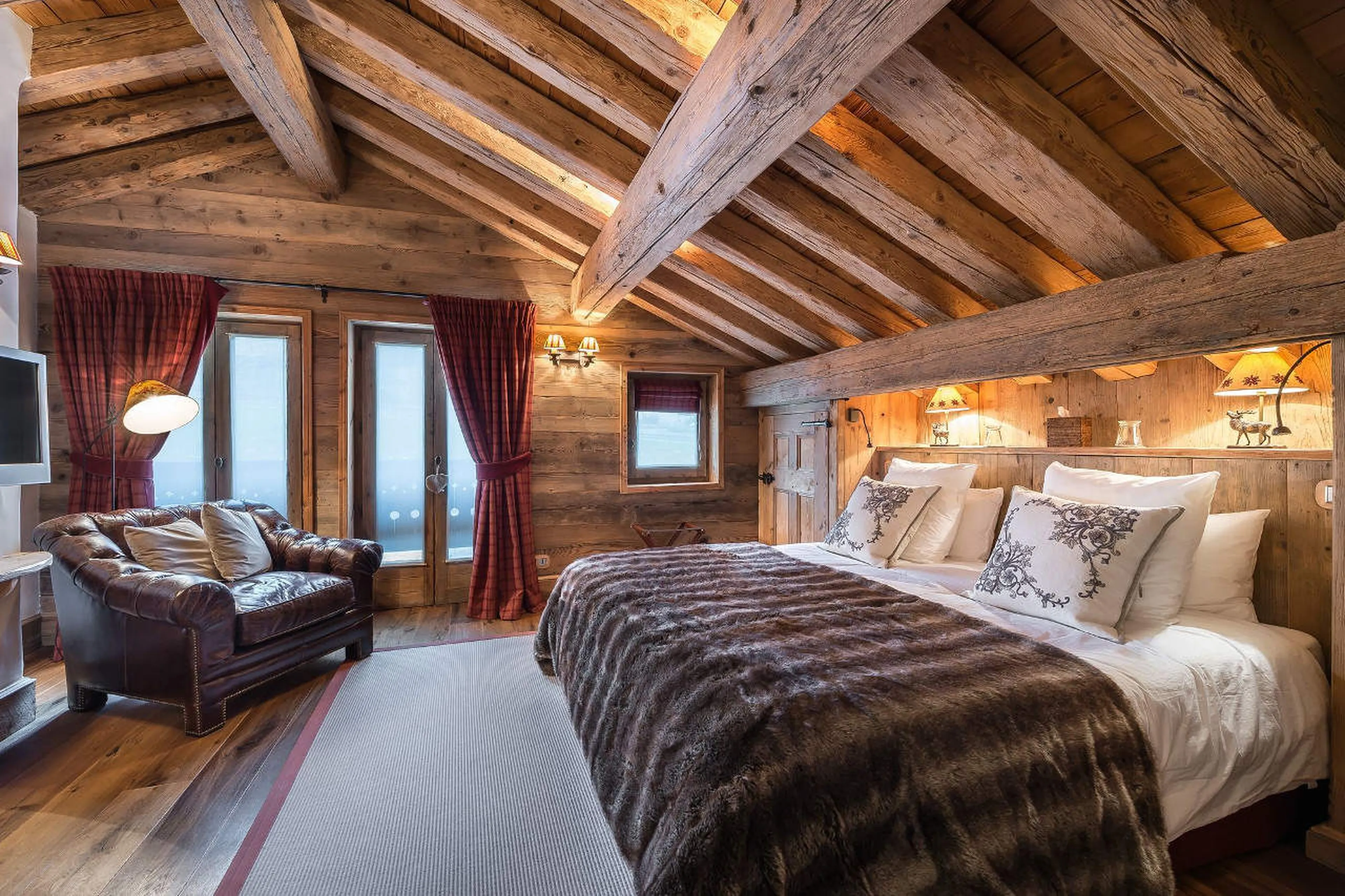 Double/twin bedroom with comfortable chair in Chalet 3 Soeurs in Courchevel 1850