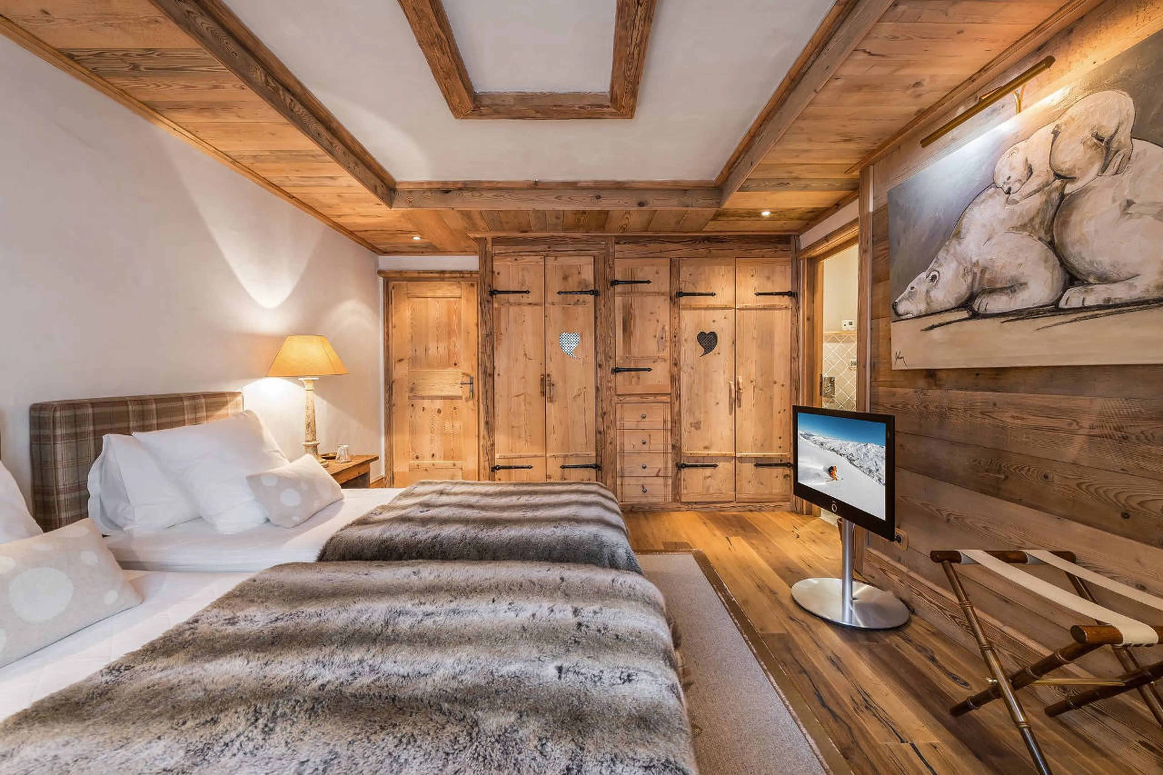 Snug twin beds and TV in bedroom of Chalet 3 Soeurs in Courchevel 1850